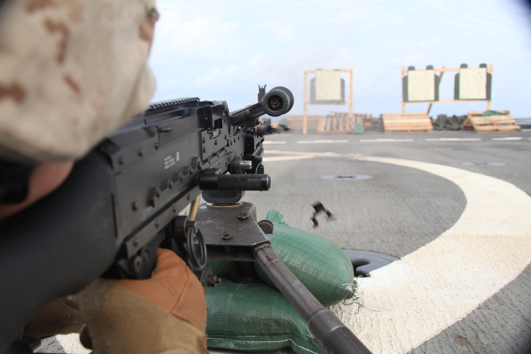 Lance Cpl. Steven Riley with Weapons Platoon, Company K, Battalion Landing Team 3/8, fires a machinegun during a live-fire exercise on the flight deck of USS Ponce, Nov. 12, 2010. 26th Marine Expeditionary Unit is currently embarked aboard the ships of Kearsarge Amphibious Ready Group operating in the 5th Fleet area of responsibility. (Official USMC Photo by Staff Sgt. Danielle M. Bacon/ Released) ::r::::n::