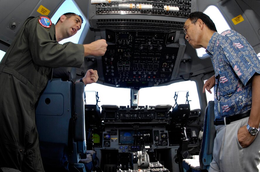 JOINT BASE PEARL HARBOR-HICKAM, Hawaii - Capt. Andy Baumann, 15th Operations Support Squadron wing airspace chief/C-17 instructor aircraft commander, provides a tour of a C-17 cockpit to Consulate General of Japan Yoshihiko Kamo, Nov. 10. Consul General Kamo visited 13th Air Force headquarters and the 15th Wing during his trip to Joint Base Pearl Harbor-Hickam. (Photo by David D. Underwood Jr.)

