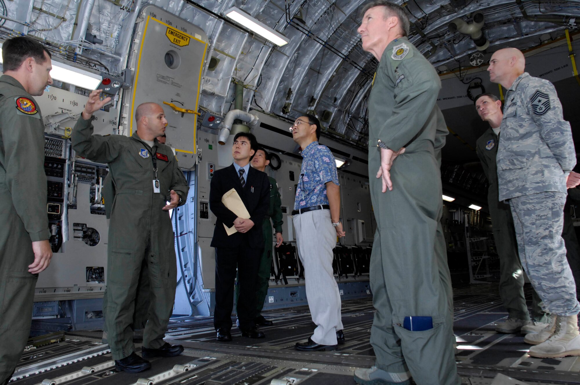JOINT BASE PEARL HARBOR-HICKAM, Hawaii - Senior Master Sgt. Terry Topouzoglou, 535th Airlift Squadron superintendent, explains the capabilities of the C-17 to Consulate General of Japan Yoshihiko Kamo, Nov. 10. Consul General Kamo visited 13th Air Force headquarters and the 15th Wing during his trip to Joint Base Pearl Harbor-Hickam. (Photo by David D. Underwood Jr.)