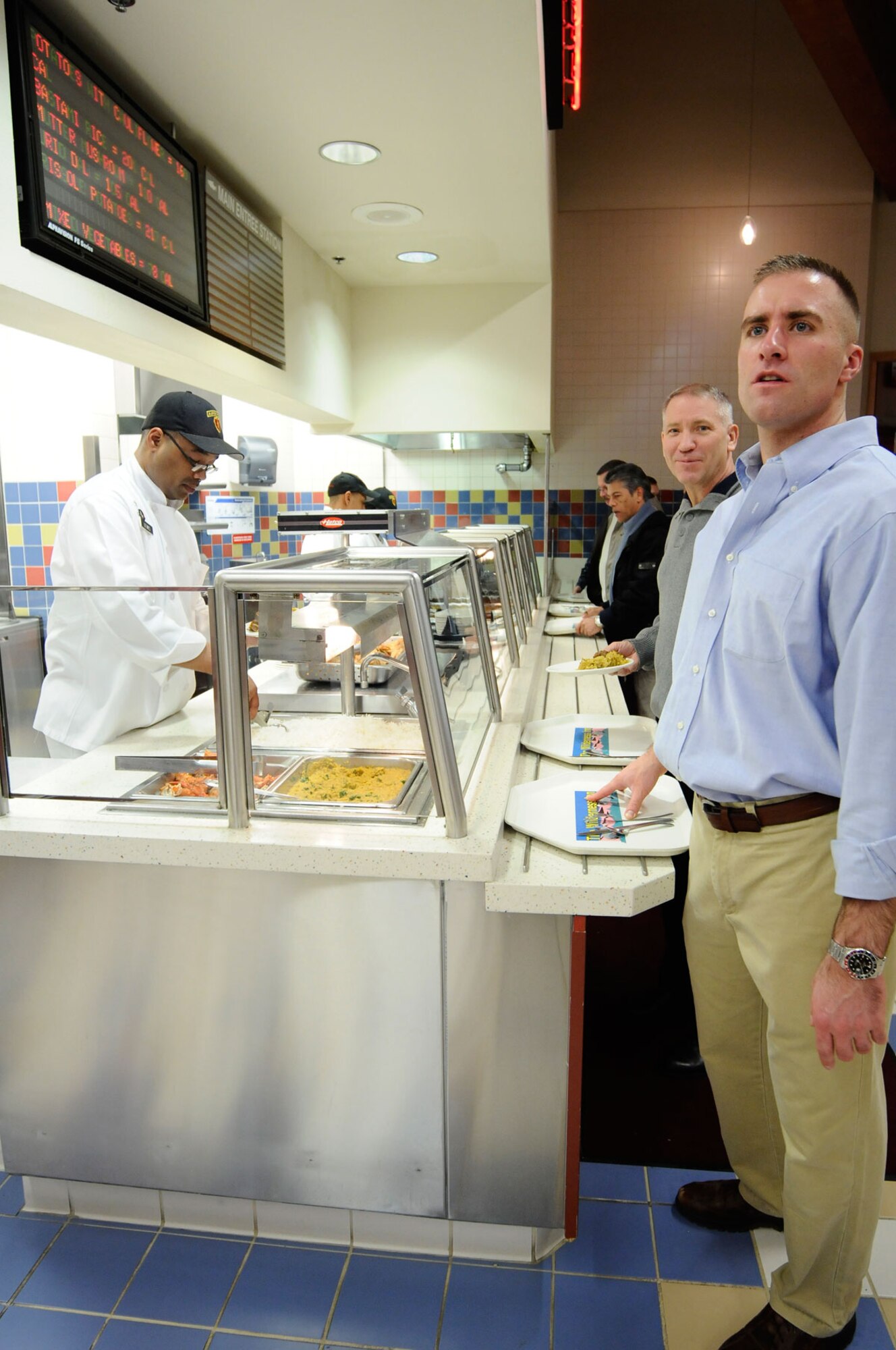 Joint Base Elmendorf-Richardson, Alaska - Army Cpt. Benjamin Hillner (right), 4th Brigade Combat Team (Airborne), 25th Infantry Division, tries to decide on his dinner choices as U.S. Army Alaska Staff Judge Advocate, Col. Randall Bagwell (center), looks on.     (U.S. Air Force photo/Percy G. Jones)
