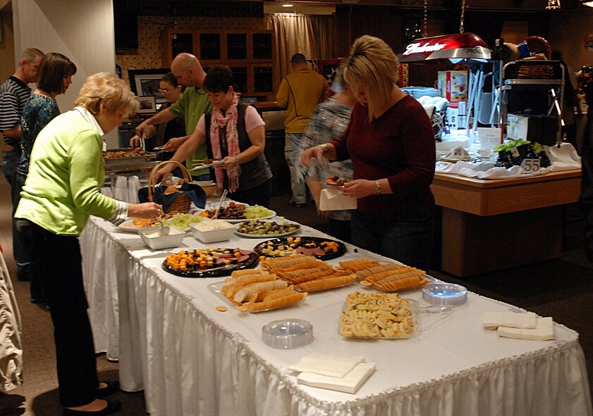 Attendees of the 2010 Malmstrom Spouse's Club Mercantile Auction select hors d’oeuvres Nov. 6 inside the Grizzly Bend Club before the auction begins. The Mercantile Auction broke the previous record, earning more than $15,000 that will be awarded as scholarships. Eligible recipients are spouses or family members of active duty or retired military service members living in Cascade County and currently earning their first post-secondary degree.  Applications will be available after Feb. 1, 2011.  For more information, please e-mail malmstromspousesclub08@yahoo.com. (U.S. Air Force photo/Staff Sgt. Dillon White)