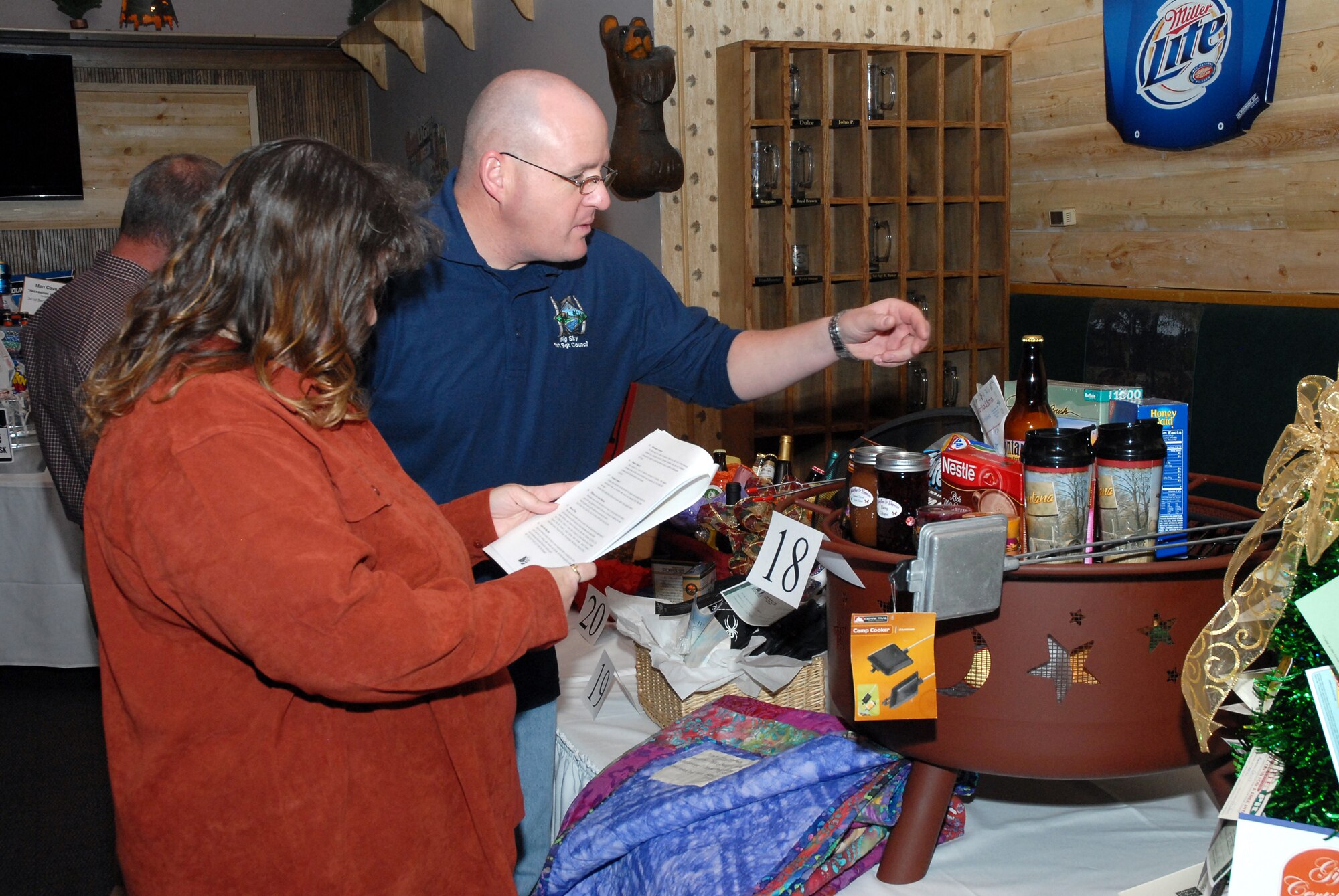 Master Sgt. Robert Baker, 341st Security Forces Squadron first sergeant, and his wife, Heather, view auction items prior to bidding Nov.6 at the Grizzly Bend Club. The 112 attendees at this year's Malmstrom Spouse's Club Mercantile Auction raised more than $15,000 that will be used for scholarships. (U.S. Air Force photo/Staff Sgt. Dillon White)