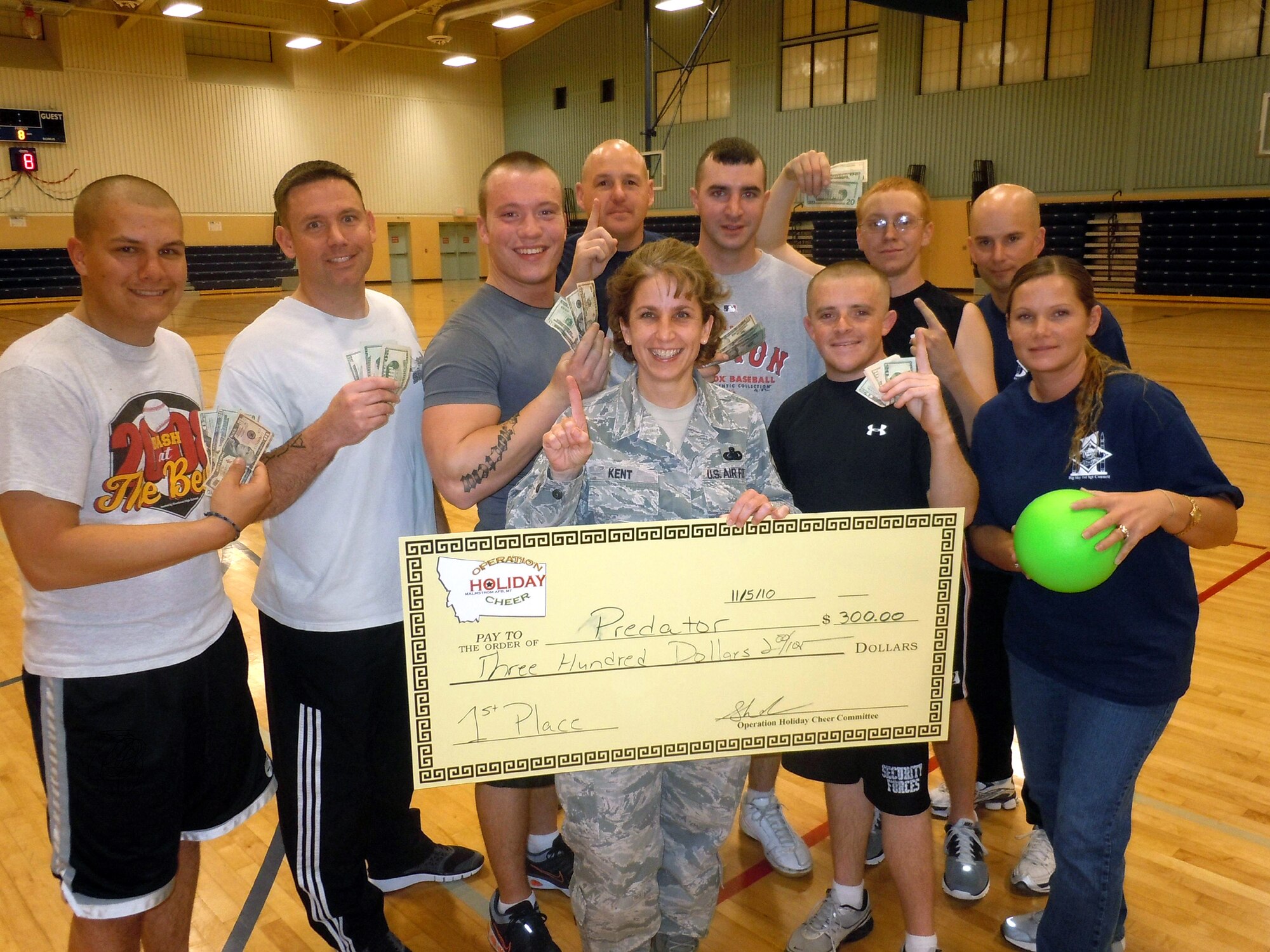 A cash prize of $300 went to Team Predator from the 741st Missile Security Forces Squadron, who won the Operation Holiday Cheer dodge ball tournament Nov. 5 at the Fitness Center. The event was the first of four events sponsored by the first sergeants council along with the 341st Force Support Squadron. Pictured from left: Airman 1st Class Shawn Sayers, Tech. Sgt. Sean Burridge, Staff Sgt. Brandon McDonald, Master Sgt. Robert Baker, Command Chief Master Sgt. Cari Kent, Staff Sgt. Scott Maciel, Airmen 1st Class James Kirkpatrick and Ethan King, and Master Sgt.'s Matthew Brenholt and Sheila Lawson.(courtesy photo)