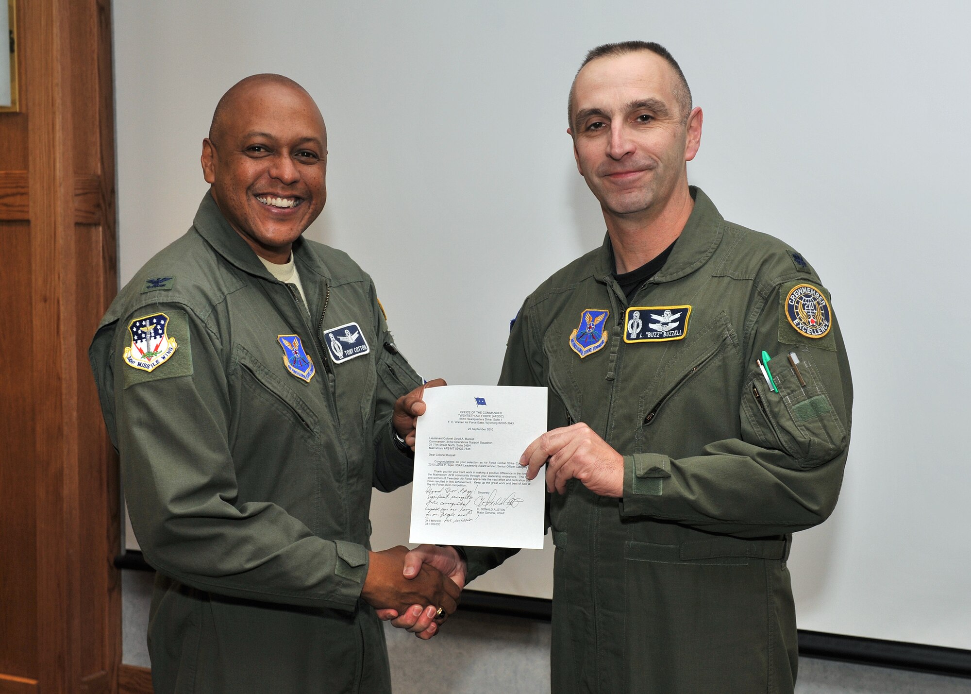 Col. Anthony Cotton, 341st Missile Wing commander, presented Lt. Col. Lloyd Buzzell with a letter of congratulations from the Twentieth Air Force Commander Maj. Gen. C. Donald Alston, prior to the start of wing stand up Nov. 1. The two officers were selected as Air Force Global Strike Command’s junior and senior officer Lance P. Sijan Award winners. Captain Wilmoth is the operations officer for the 341st Missile Security Forces Squadron and Colonel Buzzell is the commander, 341st Operation Support Squadron. (U.S. Air Force photos/John Turner)