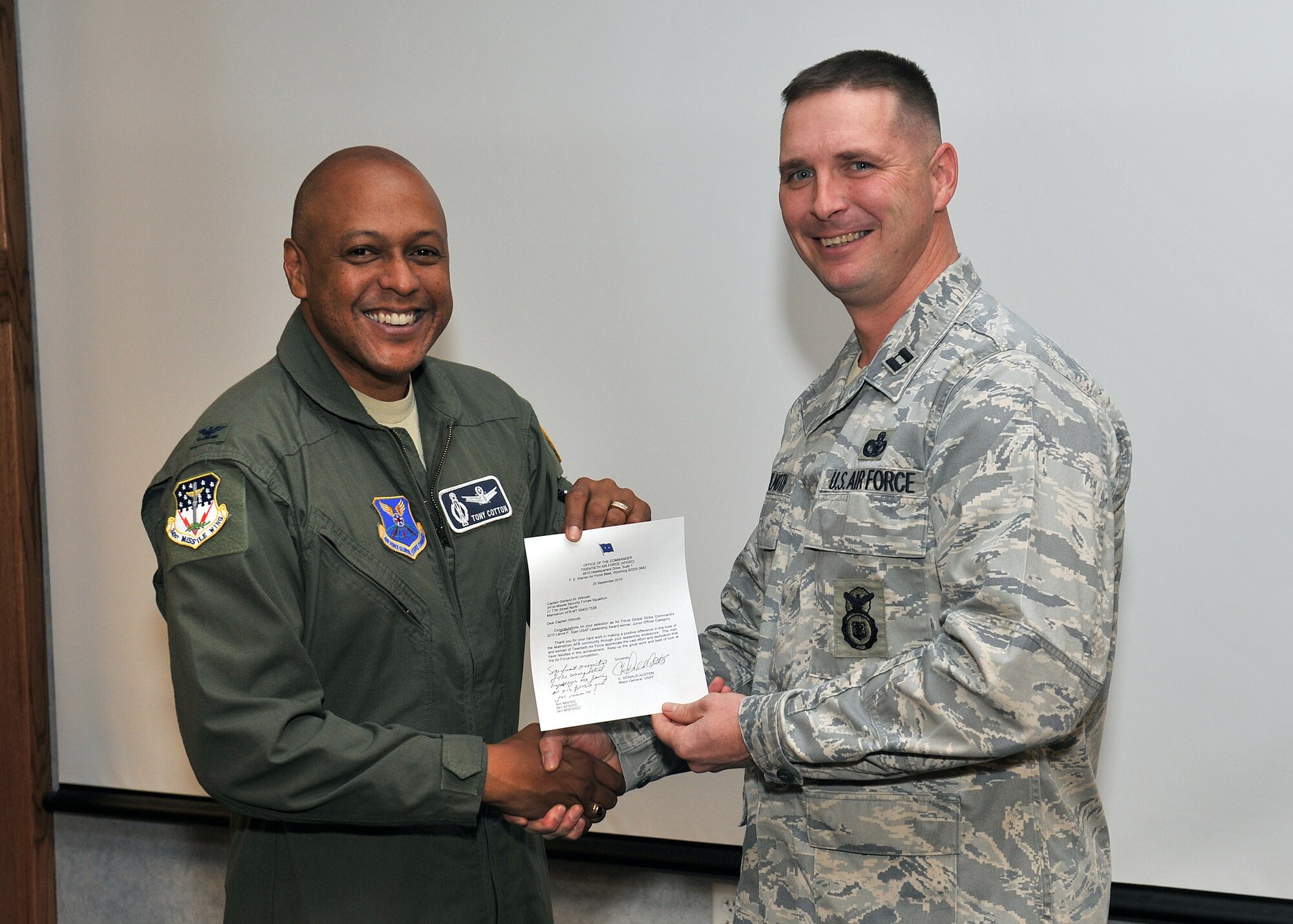 Col. Anthony Cotton, 341st Missile Wing commander, presented Capt. Garland Wilmoth (top) and Lt. Col. Lloyd Buzzell (bottom) with a letter of congratulations from the Twentieth Air Force Commander Maj. Gen. C. Donald Alston, prior to the start of wing stand up Nov. 1. The two officers were selected as Air Force Global Strike Command’s junior and senior officer Lance P. Sijan Award winners. Captain Wilmoth is the operations officer for the 341st Missile Security Forces Squadron and Colonel Buzzell is the commander, 341st Operation Support Squadron. (U.S. Air Force photos/John Turner)