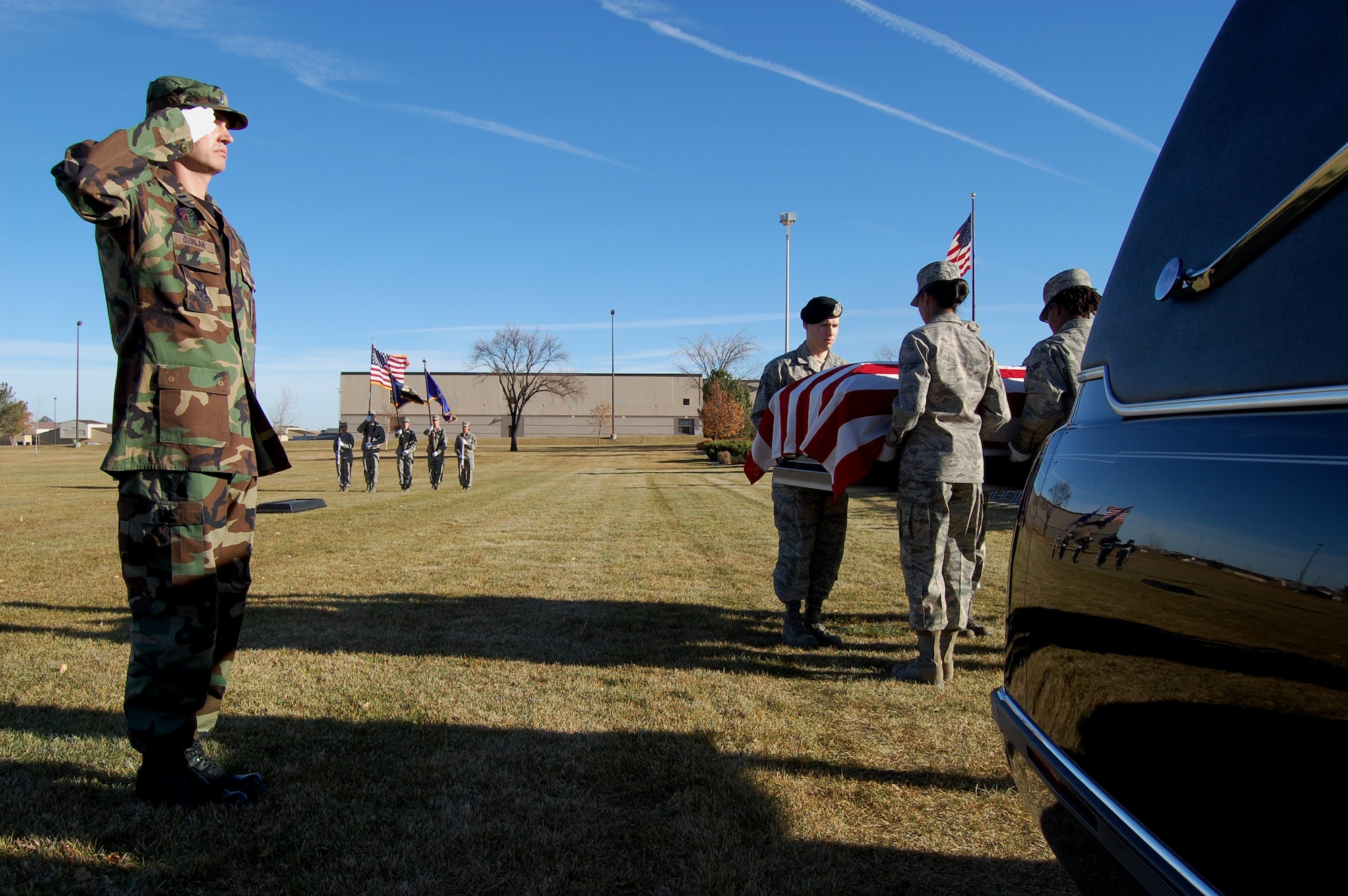 Second Lt. Brian Quinlan, 12th Missile Squadron ICBM deputy combat crew commander, renders a salute as pall bearers remove a training casket from a hearse during a ful honors funeral demonstration Nov. 5 at Medal of Honor Park. Lieutenant Quinlan was the OIC of the demonstration and one of Malmstrom's 23 newest ceremonial guardsmen to graduate from the annual base honor guard training class here. (U.S. Air Force photo/Staff Sgt. Dillon White)