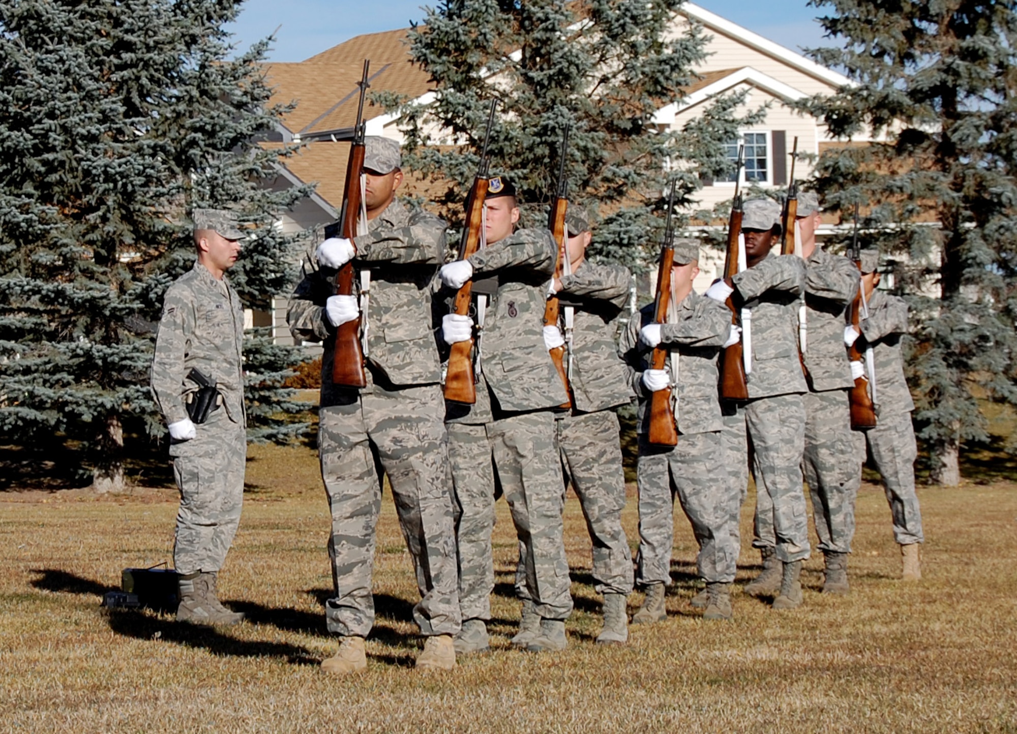 Ceremonial guardsmen graduating from the 2010 Malmstrom Base Honor Guard training course prepare to charge their M14 rifles to fire three volleys Nov. 5 at Medal of Honor Park. The firing party was part of a full honors funeral demonstration conducted in conjunction with the class graduation ceremony. (U.S. Air Force photo/Staff Sgt. Dillon White)