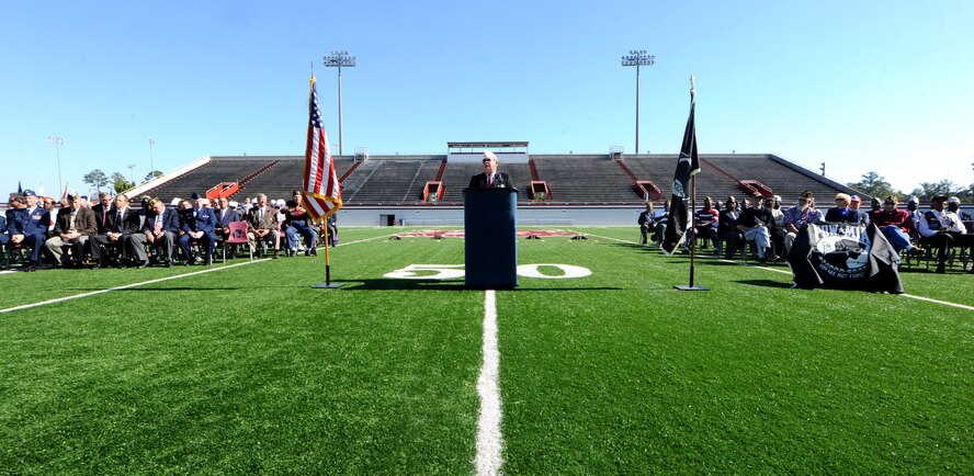 VALDOSTA, Ga. -- Phil Youngblood, master of ceremonies and veteran, speaks to students, teachers and the local community as veterans sit during the Valdosta Lowndes Annual Veteran’s Day ceremony Nov. 11. In conjunction with Moody and other organizations, LHS worked to ensure the ceremony was a success. (U.S. Air Force photo/Airman 1st Class Benjamin Wiseman)(RELEASED)