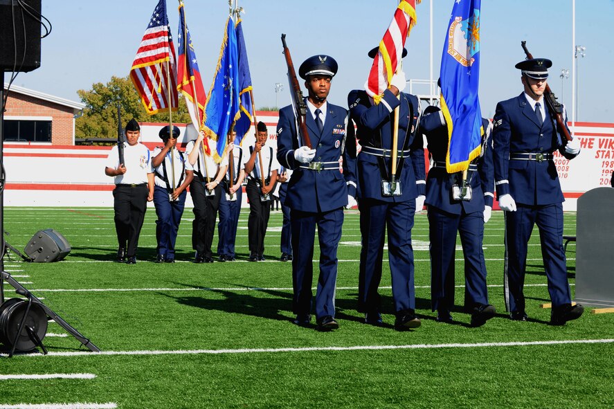 VALDOSTA, Ga. -- The Moody Air Force Base Honor Guard marches along with cadets from both the Lowndes High School Air Force and Valdosta High School Navy Junior ROTC programs to post the colors during the Valdosta Lowndes Annual Veteran’s Day ceremony Nov. 11. The cadets from both schools worked with the base honor guard to perform a successful detail during the ceremony. (U.S. Air Force photo/Airman 1st Class Benjamin Wiseman)(RELEASED)