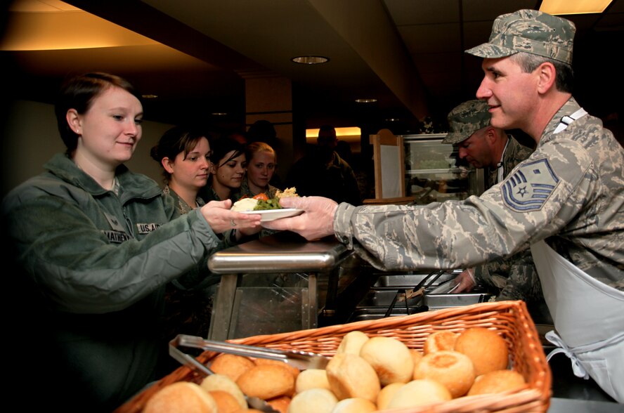 Master Sgt Ronald Lybrook, 911th Aircraft Maintenance squadron first sergeant, hands food to a 911th Airlift Wing Airman, Nov. 6. First Sergeants from around the base served food to Airmen as a thank you for their hard work and dedication. (U.S. Air Force Photo/Senior Airman Joshua J. Seybert)