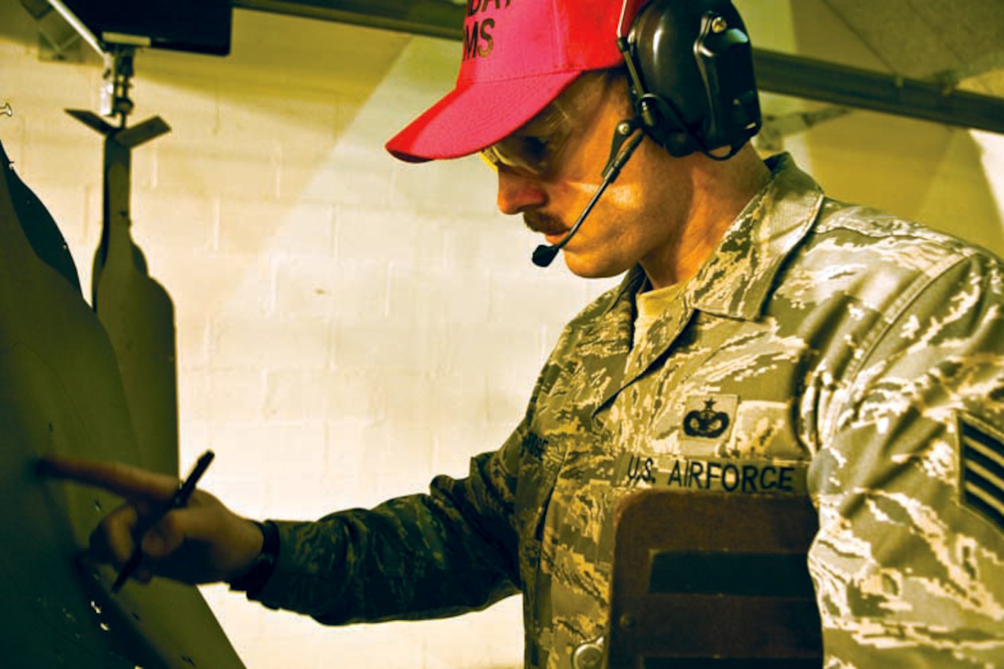 Air Force Staff Sgt. Chadwick Eldridge, 673d Security Forces Squadron, Combat Arms instructor, grades targets after and M9 qualification training at the range, Oct. 29. (U.S. Air Force photo/A1C Jack Sanders)