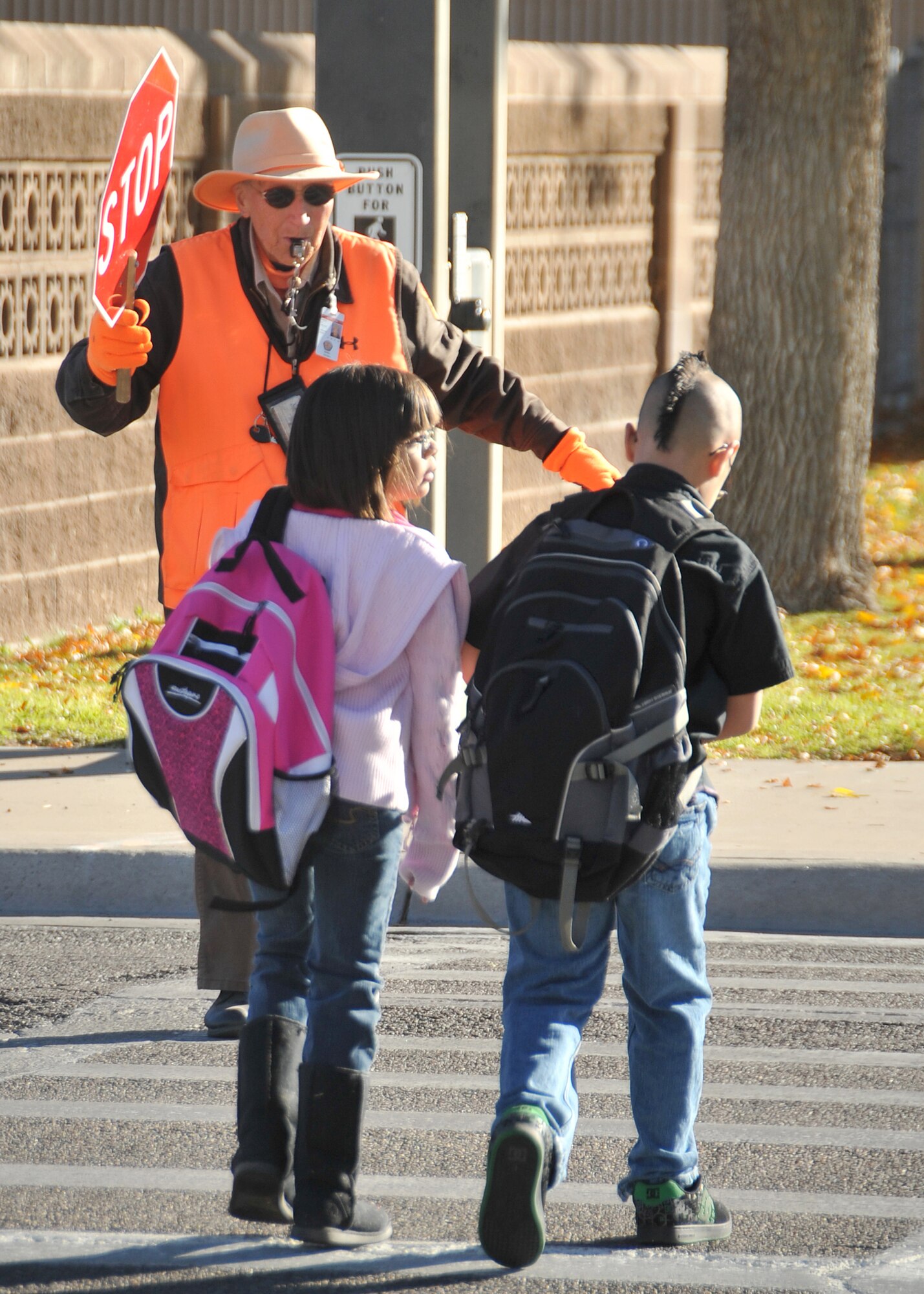 Crossing guard Shirley Wallace escorts students Nov. 8 across Wyoming Boulevard to Sandia Elementary School.  U.S. Air Force Photo by Todd Berenger.