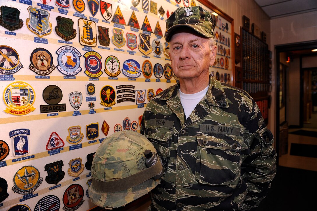 Master Sgt. (Ret.) Jack Dean wears the uniform and holds the helmet he used during the Vietnam War, at the Veterans of Foreign Wars post 1273 in Rapid City, S.D., Nov. 11.  Sergeant Dean endured five tours of duty throughout the Vietnam War, serving in both the Air Force and U.S. Navy. (U.S. Air Force photo/Staff Sgt. Marc I. Lane)
