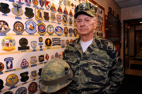 Master Sgt. (Ret.) Jack Dean wears the uniform and holds the helmet he used during the Vietnam War, at the Veterans of Foreign Wars post 1273 in Rapid City, S.D., Nov. 11.  Sergeant Dean endured five tours of duty throughout the Vietnam War, serving in both the Air Force and U.S. Navy. (U.S. Air Force photo/Staff Sgt. Marc I. Lane)