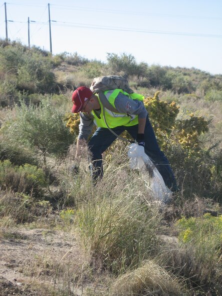 1st Lt. Ryan Davis, Kirtland CGOC President, cleans up trash on Interstate 25 as part of the Adopt-A-Highway program.  U.S. Air Force Photo by Capt. Kristen Newsome
