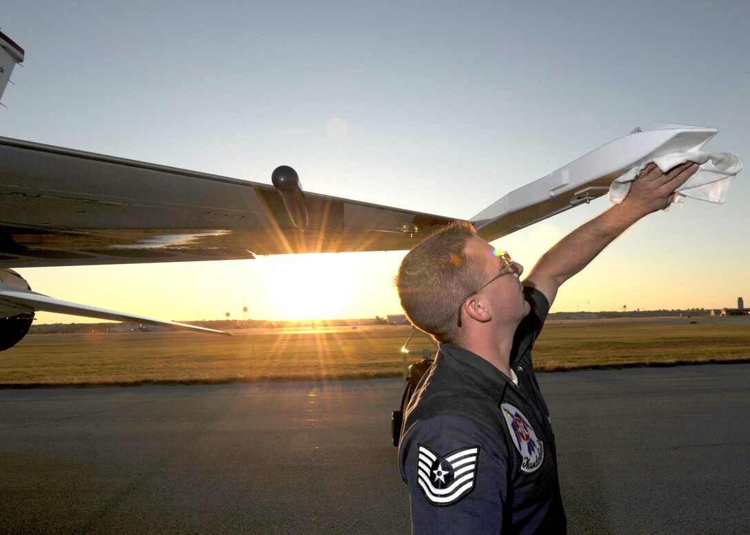 Tech. Sgt. Andrue Donaldson wipes down the missile rail on his jet following the Thunderbirds aerial demonstration at the AirFest 2010 Nov. 7, 2010, at Lackland Air Force Base, Texas. Sergeant Donaldson is a Thunderbird crew chief. (U.S. Air Force photo/Staff Sgt. Larry E. Reid Jr.)