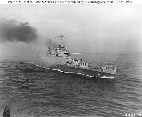 The U.S.S. Savannah (CL-42) is set afire immediately after she was hit by a German guided bomb during the Salerno operation, September 11, 1943. Smoke is pouring from the bomb's impact hole atop the ship's number three 6"/47 gun turret. (Photograph from the Army Signal Corps Collection in the U.S. National Archives.)
