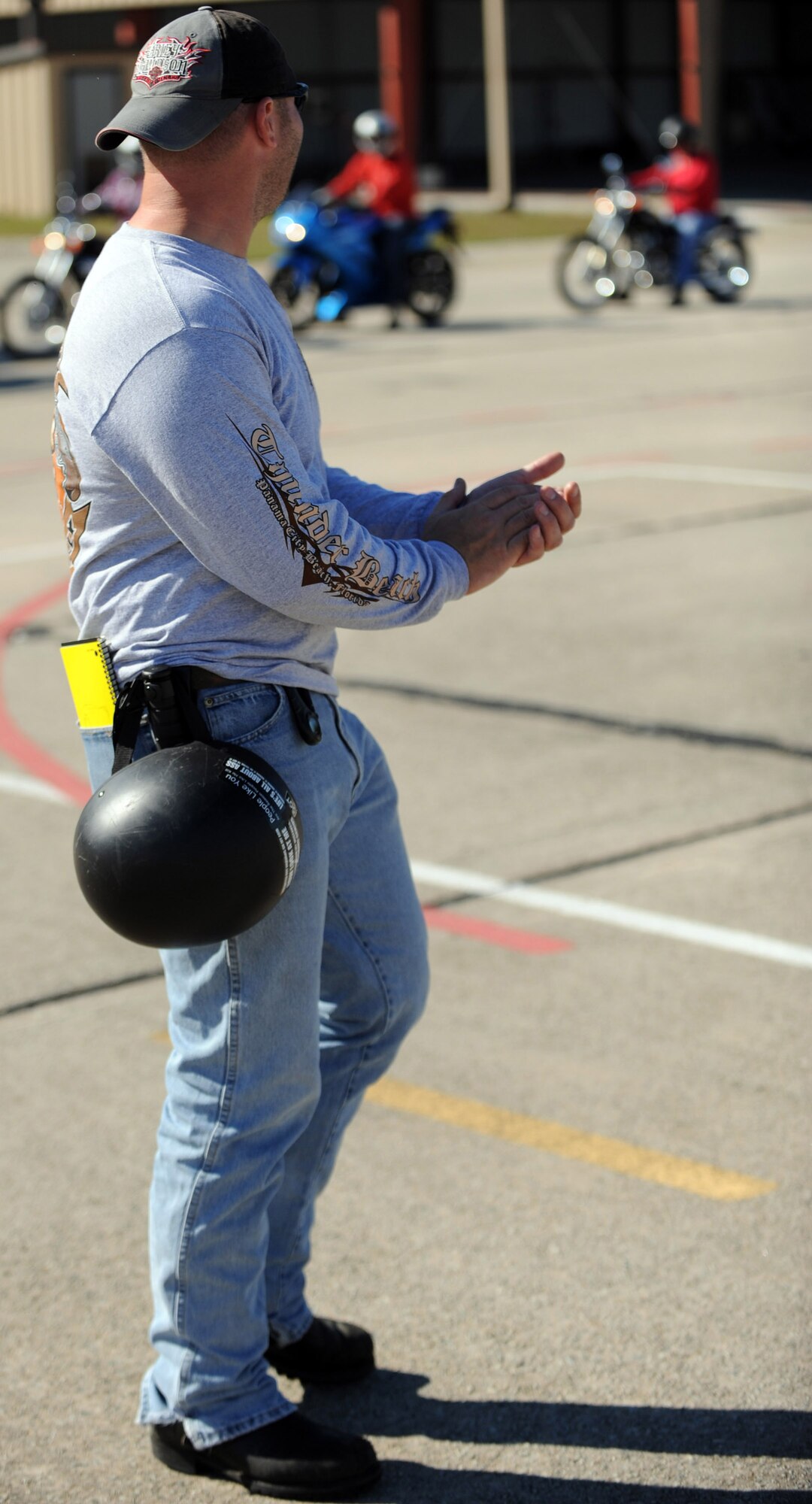 MOODY AIR FORCE BASE, Ga. -- Tech. Sgt. Russell Quattrocchi, 23rd Security Forces Squadron combat arms instructor, applauds a student for his ability to control a motorcycle's clutch Nov. 10. Sergeant Quattrocchi instructed students during a two-day motorcycle safety course. (U.S. Air Force photo/Airman 1st Class Douglas Ellis)(RELEASED)