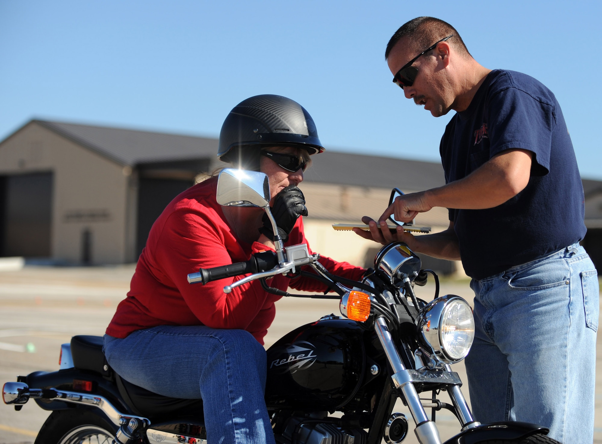 MOODY AIR FORCE BASE, Ga. -- Cliff Sowder, motorcycle safety course instructor, shows a student proper turning procedures Nov. 10. Mr. Sowder demonstrated how to properly shift weight when making a turn. (U.S. Air Force photo/Airman 1st Class Douglas Ellis)(RELEASED)
