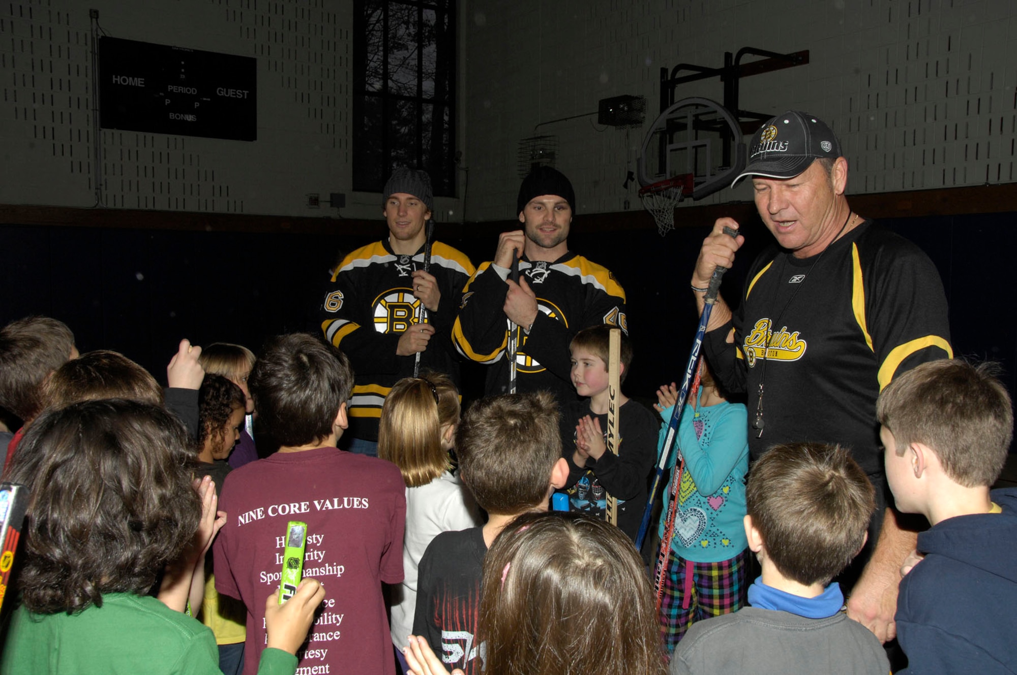 HANSCOM AIR FORCE BASE, Mass. – Blake Wheeler and Mark Stuart (left and middle), members of the Boston Bruins hockey team, and Tommy Songin (right), a former Bruins player, visit with Hanscom youth during a base hockey clinic on Nov. 8. Both Wheeler and Stuart donated $5,000 worth of tickets for local military families to attend the Bruins hockey game on Nov. 15. Military families interested in tickets may visit www.uso-newengland.org or call 617-720-4949. (U.S. Air Force photo by Linda LaBonte Britt)
