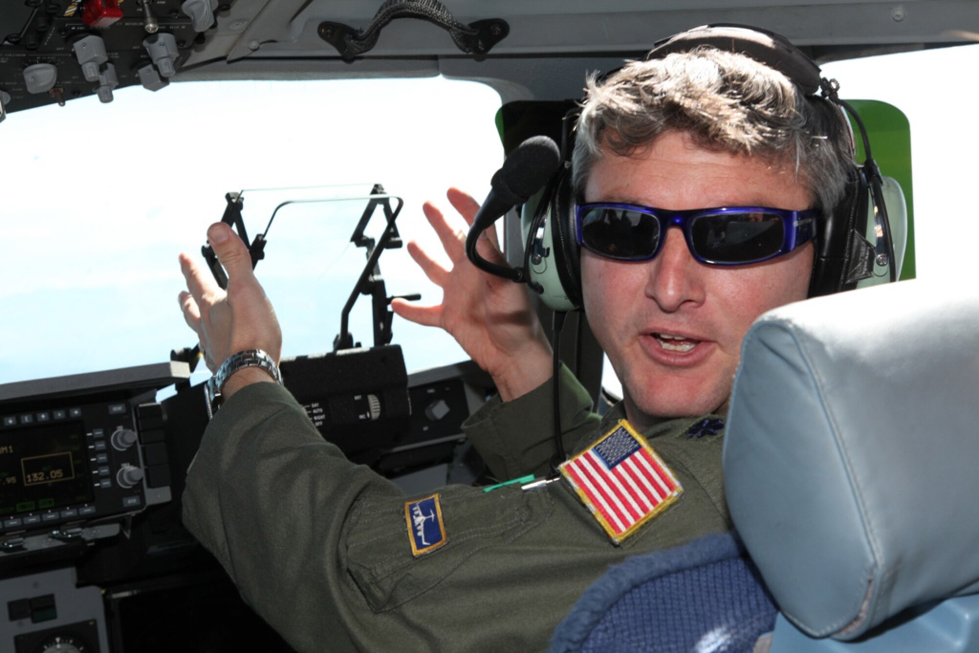 BEALE AIR FORCE BASE, Calif.- Lt. Col. Scott Ryan, a pilot from the 97th Airlift Squadron, Joint Base Lewis-McChord, Wash., explains the mechanics of the heads-up display on for a C-17 Globemaster III in October. This flight, which involved aeromedical evacuation crew training, was an orientation flight to show how aircrews and AE  crews work together to get the injured and wounded from the battlefield to facilities that provide proper care. (U.S. Air Force photo/Tech. Sgt. Kenneth McCann)