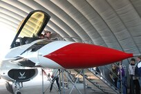 Visitors to AirFest 2010 take a look inside the cockpit of an Air Force Thunderbird static display. Multiple static displays gave visitors an up close look at today's U.S. military airpower. Vintage aircraft on the flightline included a B-25 Mitchell, the Republic P-47, and the F4U-5 Corsair. (U.S. Air Force photo/Robbin Cresswell)