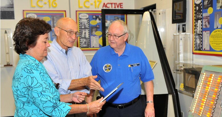 Just one of many interested visitors to the new Air Force Space and Missile History Center, Mr. Bob Sieck (center), the NASA Space Shuttle Launch Director from 1985-1995 and a Debus Award Winner, is fascinated by what he discovered inside the new center located off State Road 401 just outside of Cape Canaveral Air Force Station's Gate 1 entrance on Tuesday.  Mr. Sieck, along with Ms. Emily Perry, the History Center Director, and Mr. Bob Willis, a History Center volunteer, are standing in front of a launch console originally from the Launch Complex 19 Blockhouse where Mr. Sieck once worked.     
