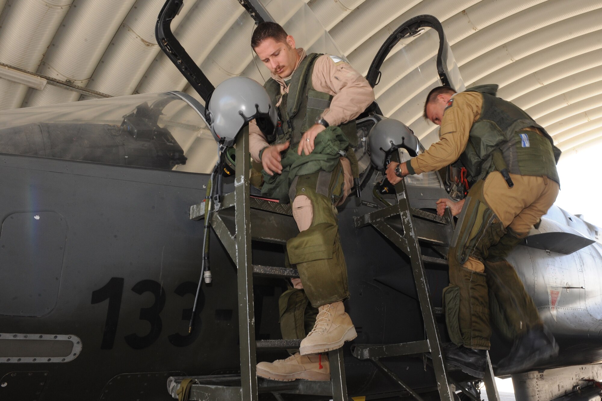 Maj. Skyler Hester and French Air Force Capt. Mathieu Boireau prepare to leave for a combat mission in a Mirage 2000D Nov. 11, 2010, at Kandahar Airfield, Afghanistan.  Major Hester from Kalaheo, Hawaii, is an instructor pilot assigned to the French 1/3 Fighter Squadron. He is deployed with the French unit as part of the three-year foreign exchange pilot program. (U.S. Air Force photo by Tech. Sgt. Chad Chisholm/Released)
