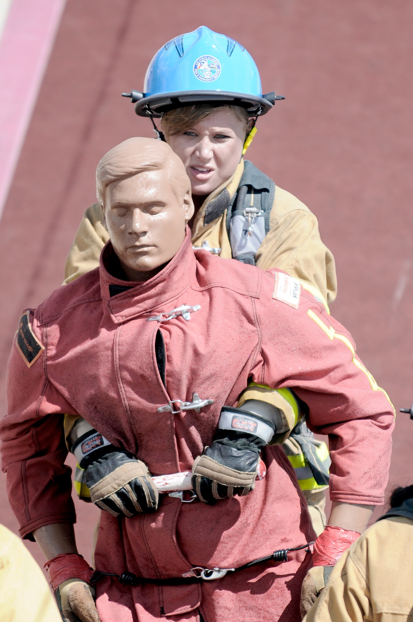 Airman 1st Class Jessica Morehouse drags a rescue dummy backwards across the finish line during a firefighter combat challenge June 27, 2009. In her first-ever challenge, Airman Morehouse a member of the ladies' tandem team and the ladies' relay team at the Academy, both of which are ranked number one in the world. (U.S. Air Force photo/Mike Kaplan)