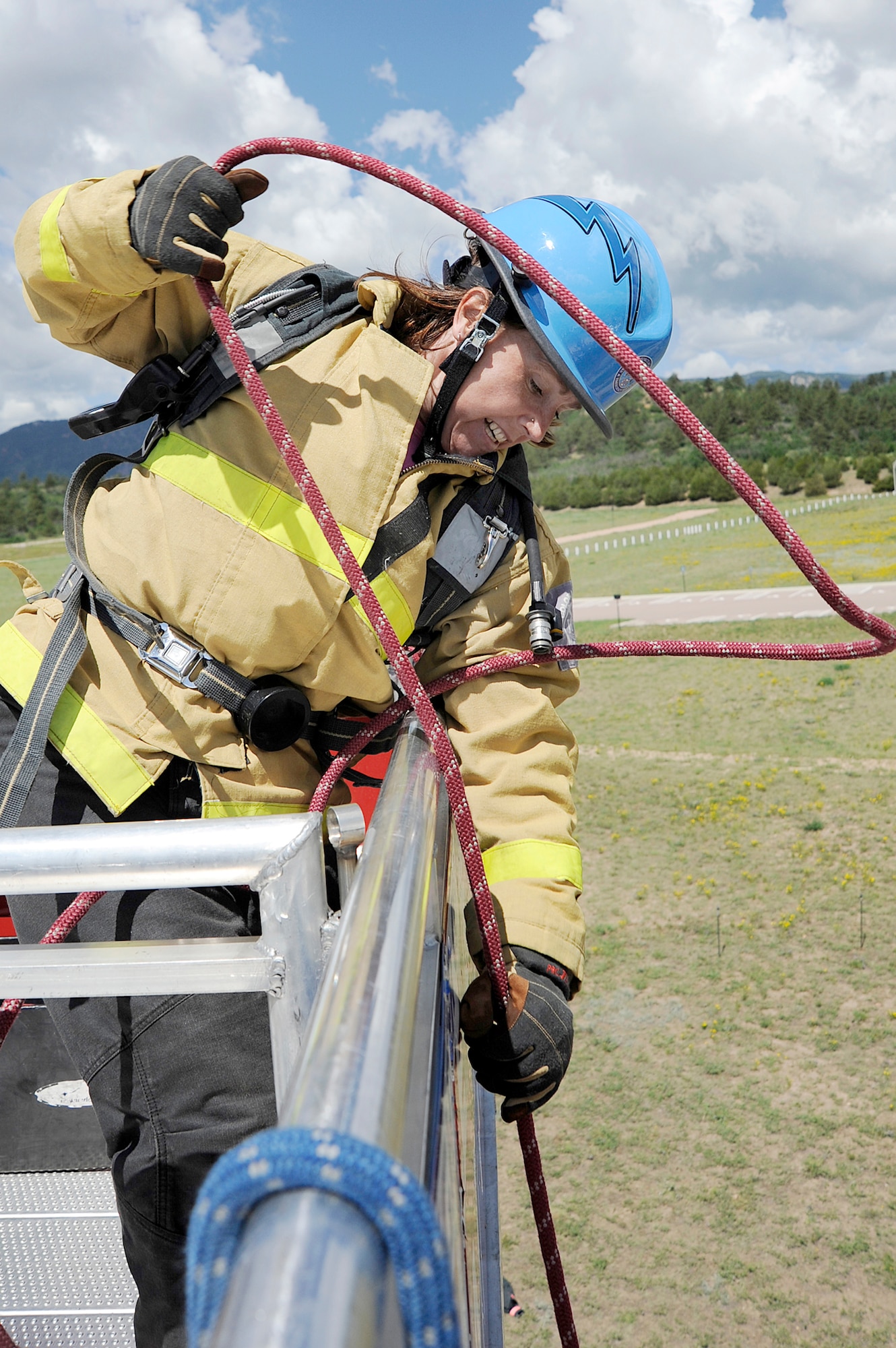 Firefighter Stacy Billapando from the Colorado Springs, Colo., Fire Department hoists a rope attached to a 45-pound fire hose from five stories up during a firefighter challenge at the Air Force Academy June 27, 2009. Ms. Billapando, the world's top-ranked female firefighter, will join the Academy ladies' tandem firefighter team at World Firefighter Combat Challenge XVIII, scheduled to be held in Las Vegas Nov. 16 through 20. (U.S. Air Force photo/Mike Kaplan)