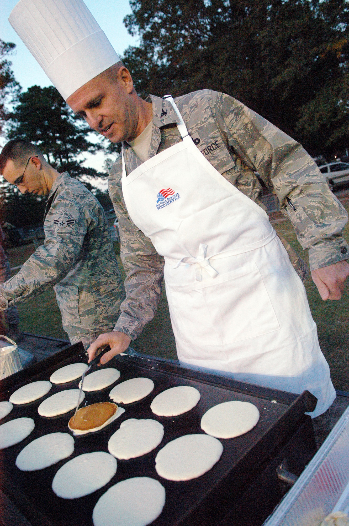 Col. Carl Buhler cooks a griddle full of pancakes at the 2nd Annual Pancake Flip. U. S. Air Force photo by Sue Sapp