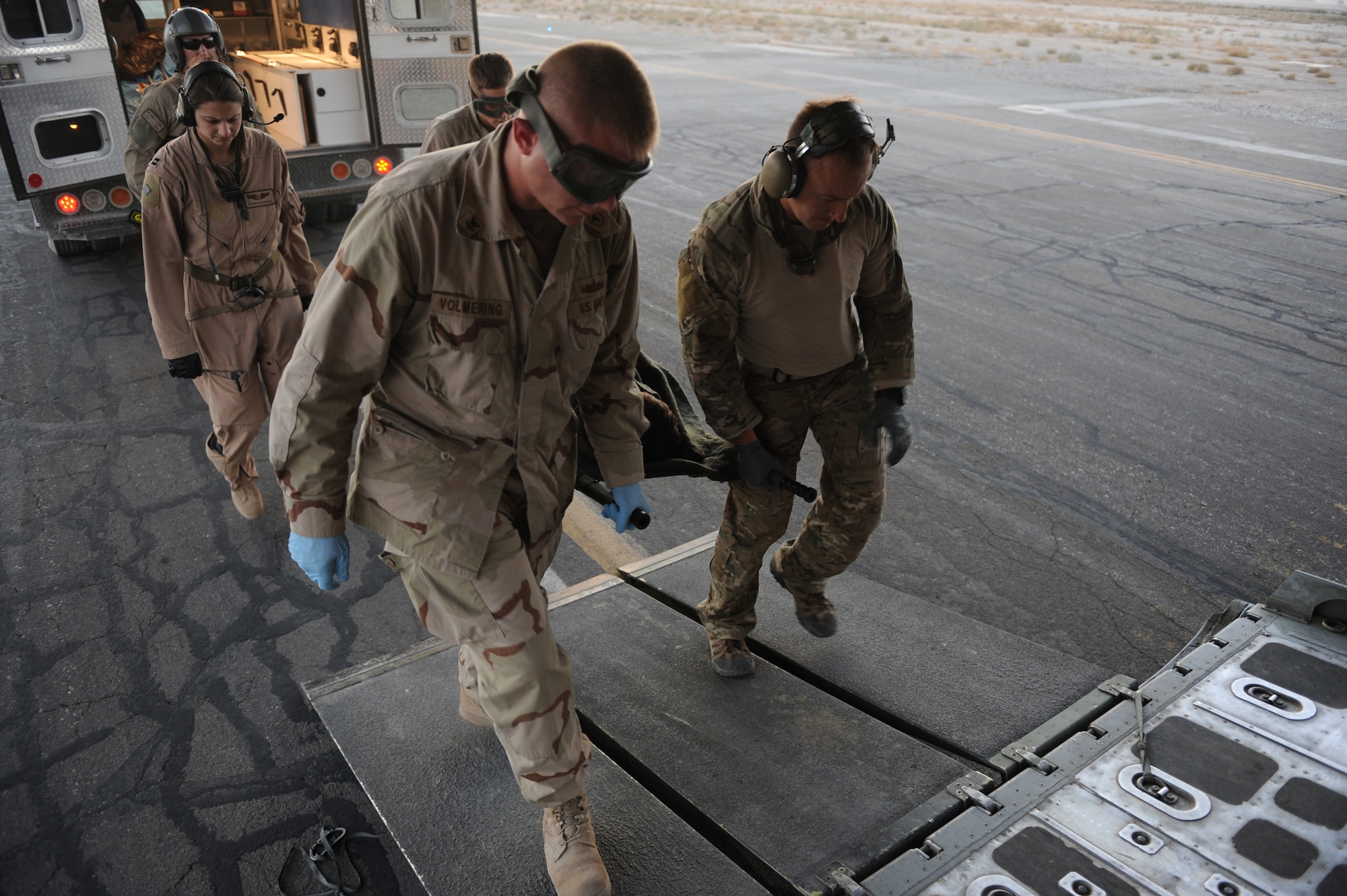 Pararescuemen and medical personnel litter carry an injured Afghan civilian on to an HC-130P King Nov. 5, 2010, at Bagram Airfield, Afghanistan. The 79th Expeditionary Rescue Squadron transports injured military members and Afghan civilians for medical treatment to various bases throughout Afghanistan. (U.S. Air Force photo by Tech. Sgt. Chad Chisholm/Released)