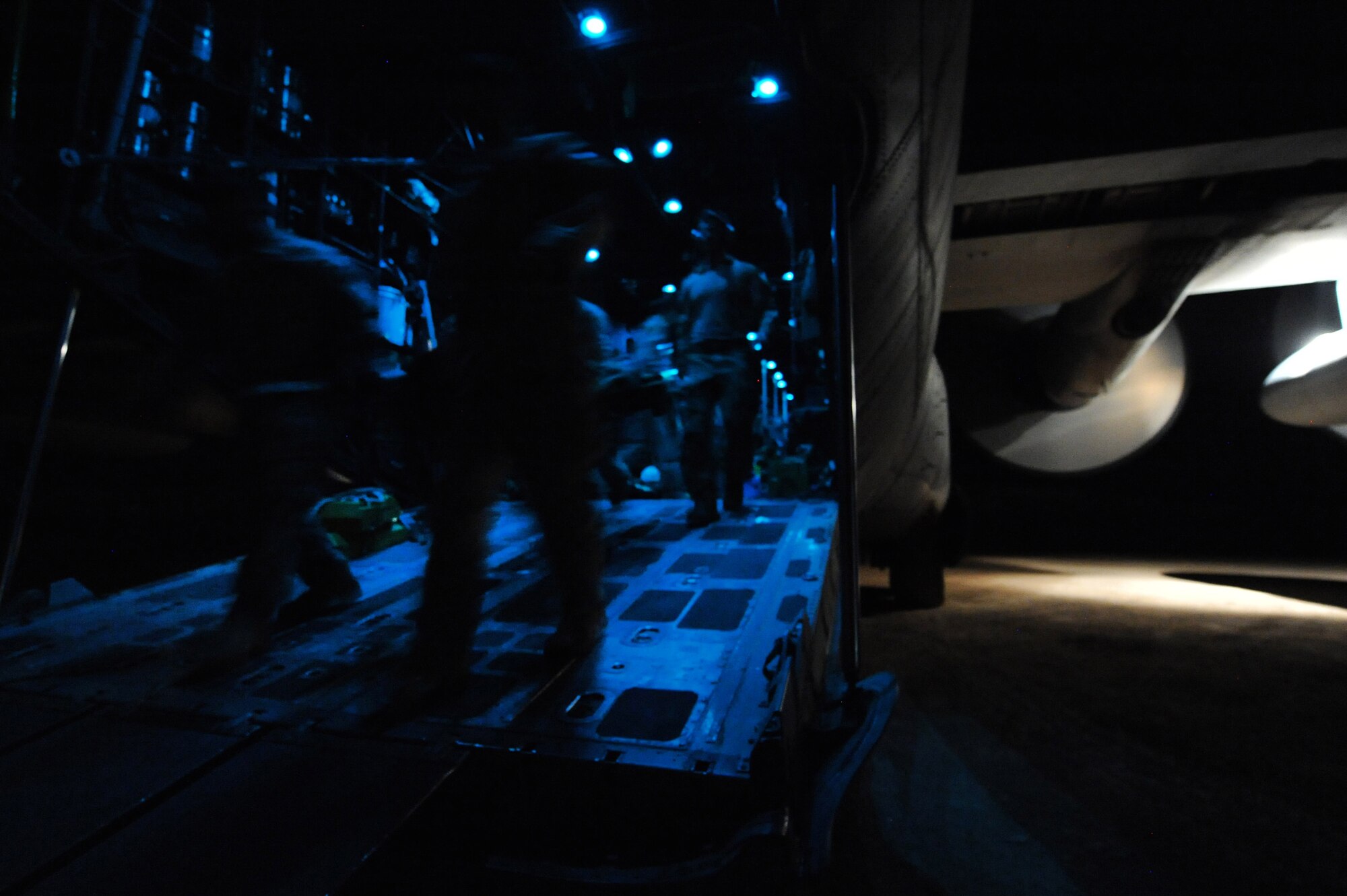 Pararescuemen and medical personnel litter carry an injured Afghan civilian from a HC-130P King Nov. 5, 2010, at Tarin Kowt Airfield, Afghanistan. The 79th Expeditionary Rescue Squadron transports injured military members and Afghan civilians for medical treatment to various bases throughout Afghanistan. (U.S. Air Force photo by Tech. Sgt. Chad Chisholm/Released)