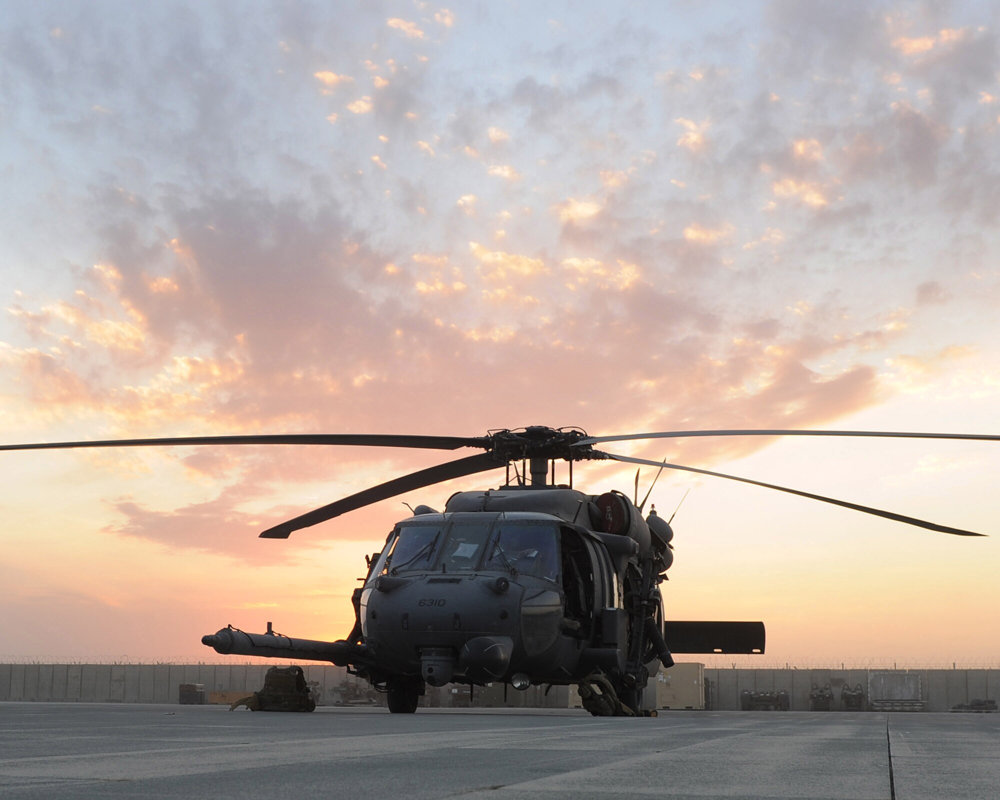A HH-60G Pave Hawk helicopter on alert at dusk, Nov. 5, 2010, at Camp Bastion, Afghanistan. The 26th Expeditionary Rescue Squadron uses the HH-60G helicopter to conduct combat search and rescue missions as well as transporting injured military members and Afghan civilians for medical treatment. (U.S. Air Force photo by Tech. Sgt. Chad Chisholm/Released) 