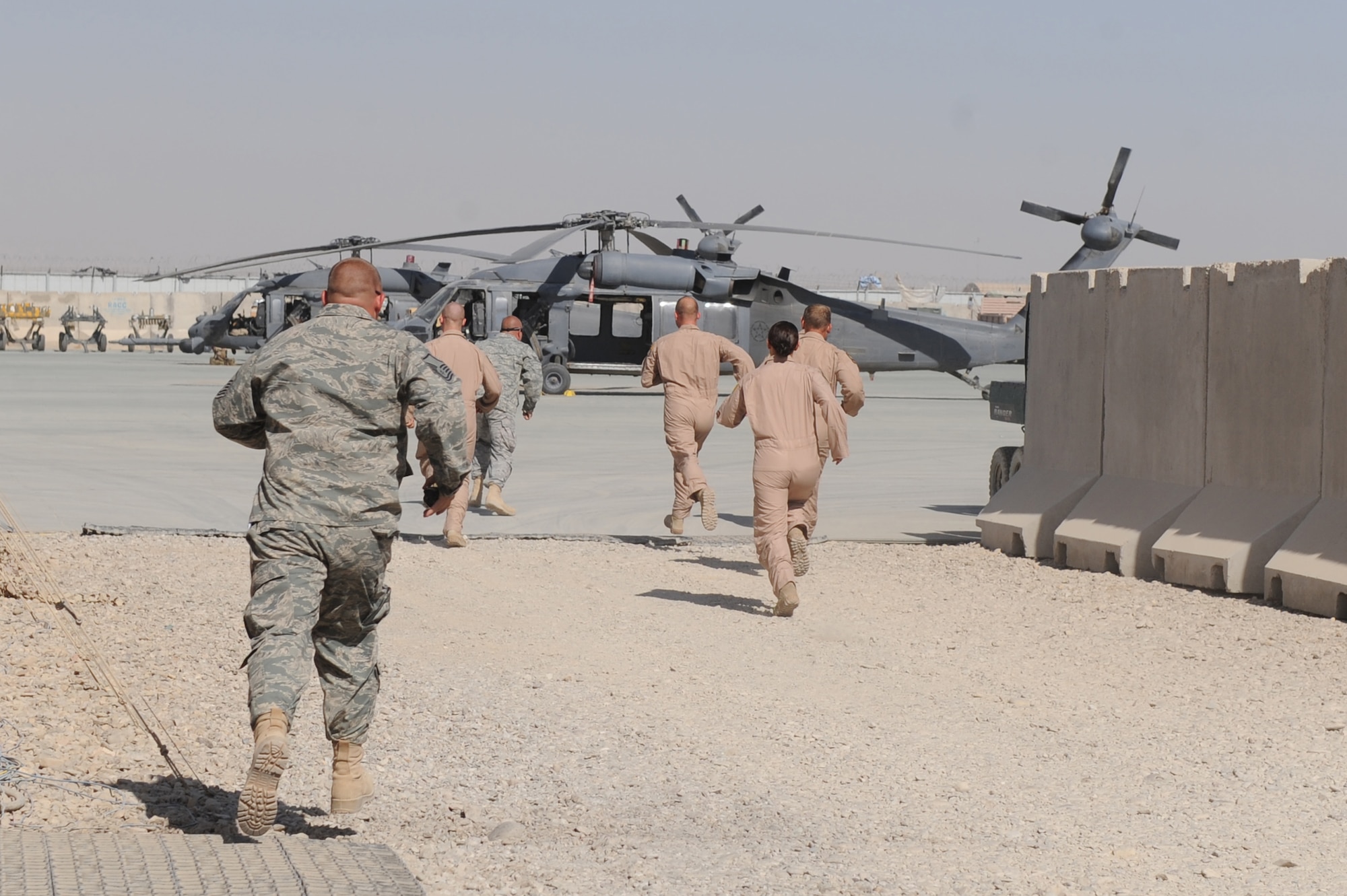 Airmen of the 26th Expeditionary Rescue Squadron sprint to an alert HH-60G Pave Hawk helicopter after receiving a mission notice Nov. 6, 2010, at Camp Bastion, Afghanistan. The 26th Expeditionary Rescue Squadron uses the HH-60G helicopter to conduct combat search and rescue missions as well as transporting injured military members and Afghan civilians for medical treatment. (U.S. Air Force photo by Tech. Sgt. Chad Chisholm/Released)