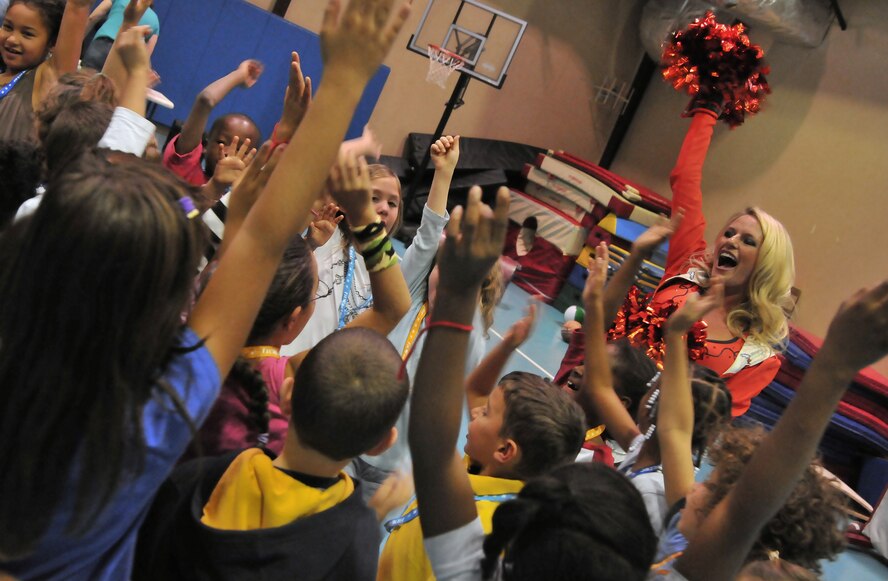 Brianne Bateman, Denver Broncos cheerleader, teaches Incirlik children a cheer at the youth center Nov. 5, 2010 Incirlik Air Base, Turkey. The cheerleaders made several morale and educational appearances around the base including a radio show with the Incirlik Armed Forces Network, a cheer clinic with children at the youth center, met with Security Forces Airmen and ended with a performance at the consolidated club. (U.S. Air Force photo by Senior Airman Alexandre Montes/Released)  