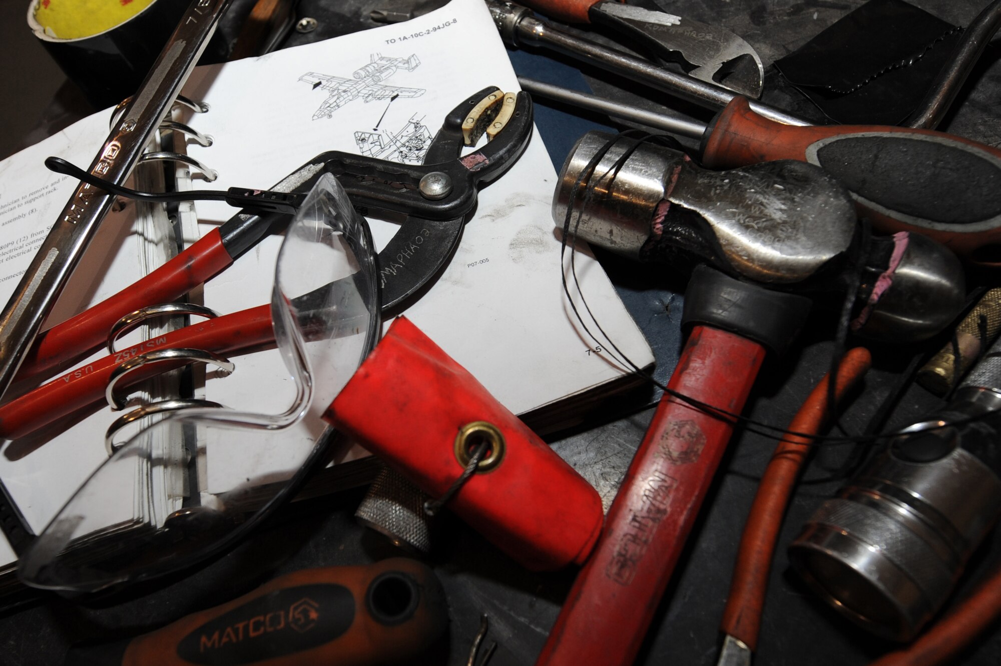 Airmen use various tools and instruction orders during a phase inspection of an A-10C Thunderbolt II, Nov. 10, 2010, at Kandahar Airfield, Afghanistan. A phase inspection is an extensive process of servicing the airframe integrity, hydraulic system and wiring systems to make sure they are compliant with standards.  (U.S. Air Force photo by Tech. Sgt. Chad Chisholm/Released)