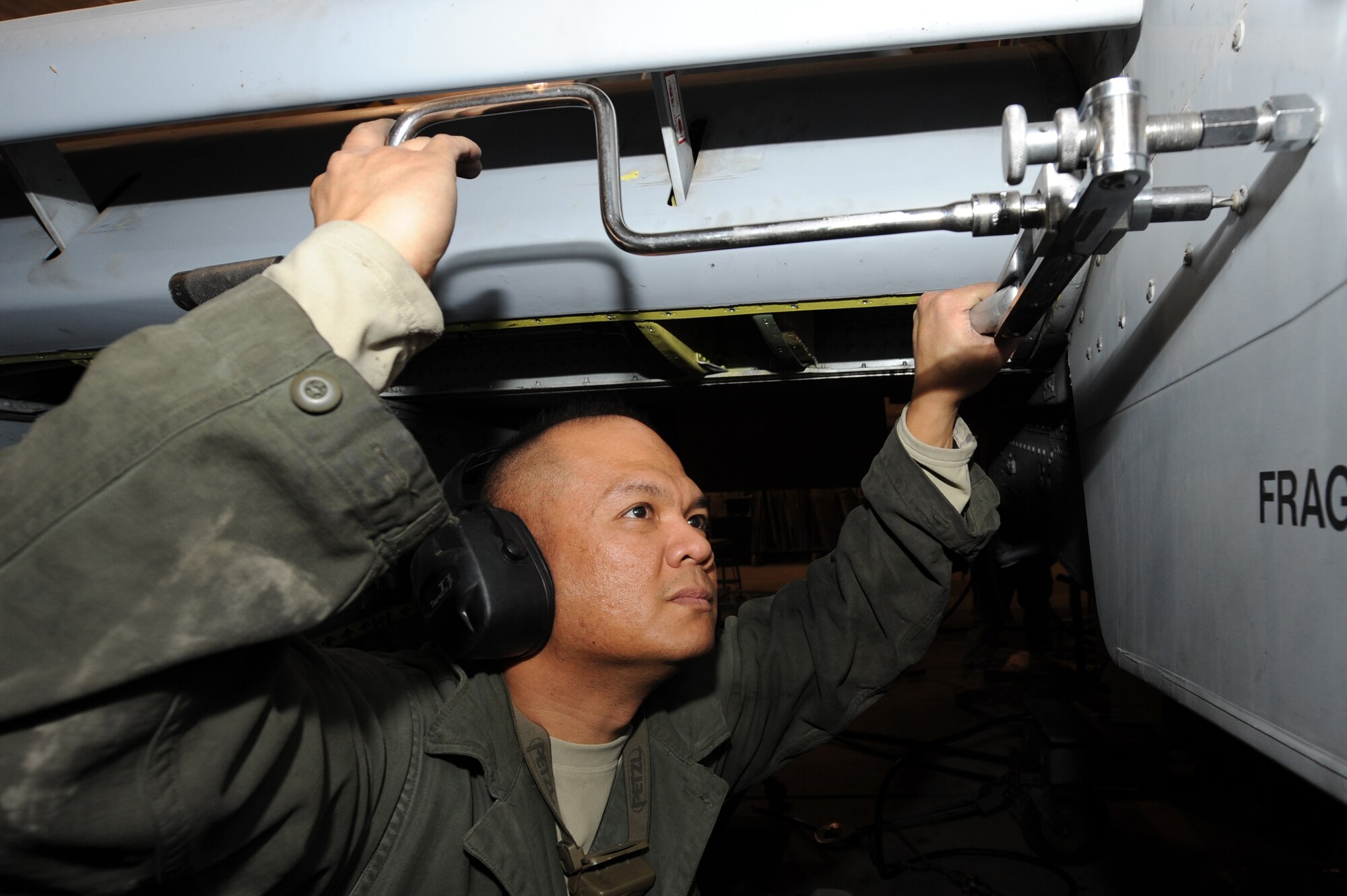 Tech. Sgt. Vincent Asuncion removes screws from a panel of an A-10C Thunderbolt II during a phase inspection Nov. 10, 2010, at Kandahar Airfield, Afghanistan. Sergeant Asuncion is an aircraft armament systems craftsman assigned to the 451th Expeditionary Maintenance Squadron A-10 Aircraft Maintenance Unit. (U.S. Air Force photo by Tech. Sgt. Chad Chisholm/Released) 