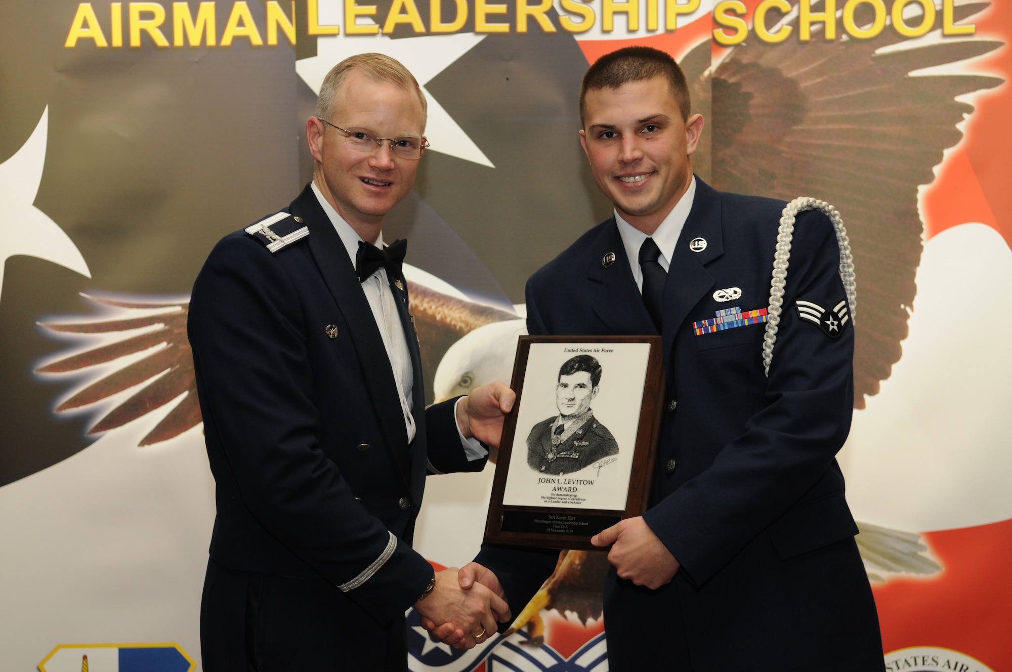 SPANGDAHLEM AIR BASE, Germany – Col. Christopher Weggeman, 52nd Fighter Wing commander, presents the John L. Levitow Award to Senior Airman Kevin Hart, 52nd Component Maintenance Sqaudron, during the Airman Leadership School class 11-A graduation Nov. 10 at Club Eifel. (U.S. Air Force photo/Staff Sgt. Benjamin Wilson)