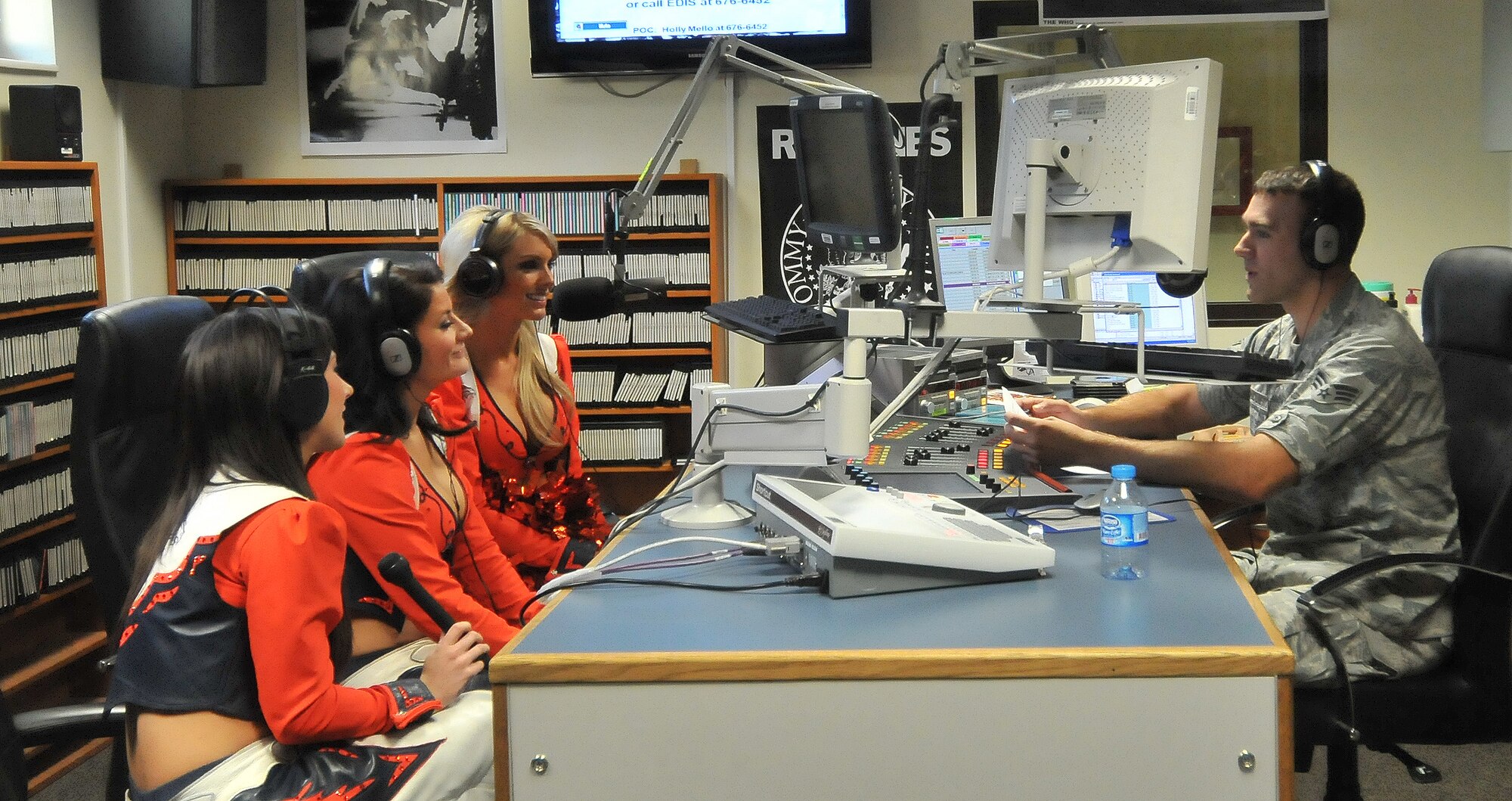 Allyson Daniels, Tara Battiato and Candace Wilson, Denver Broncos cheerleaders, make a guest appearance during the afternoon radio show with Senior Airman John Archiquette, Armed Forces Network broadcaster, Nov. 5, 2010 at Incirlik Air Base, Turkey. The cheerleaders made several morale and educational appearances around the base including a radio show with the Incirlik Armed Forces Network, a cheer clinic with children at the youth center, met with Security Forces Airmen and ended with a performance at the consolidated club. (U.S. Air Force photo by Senior Airman Alexandre Montes/Released)  