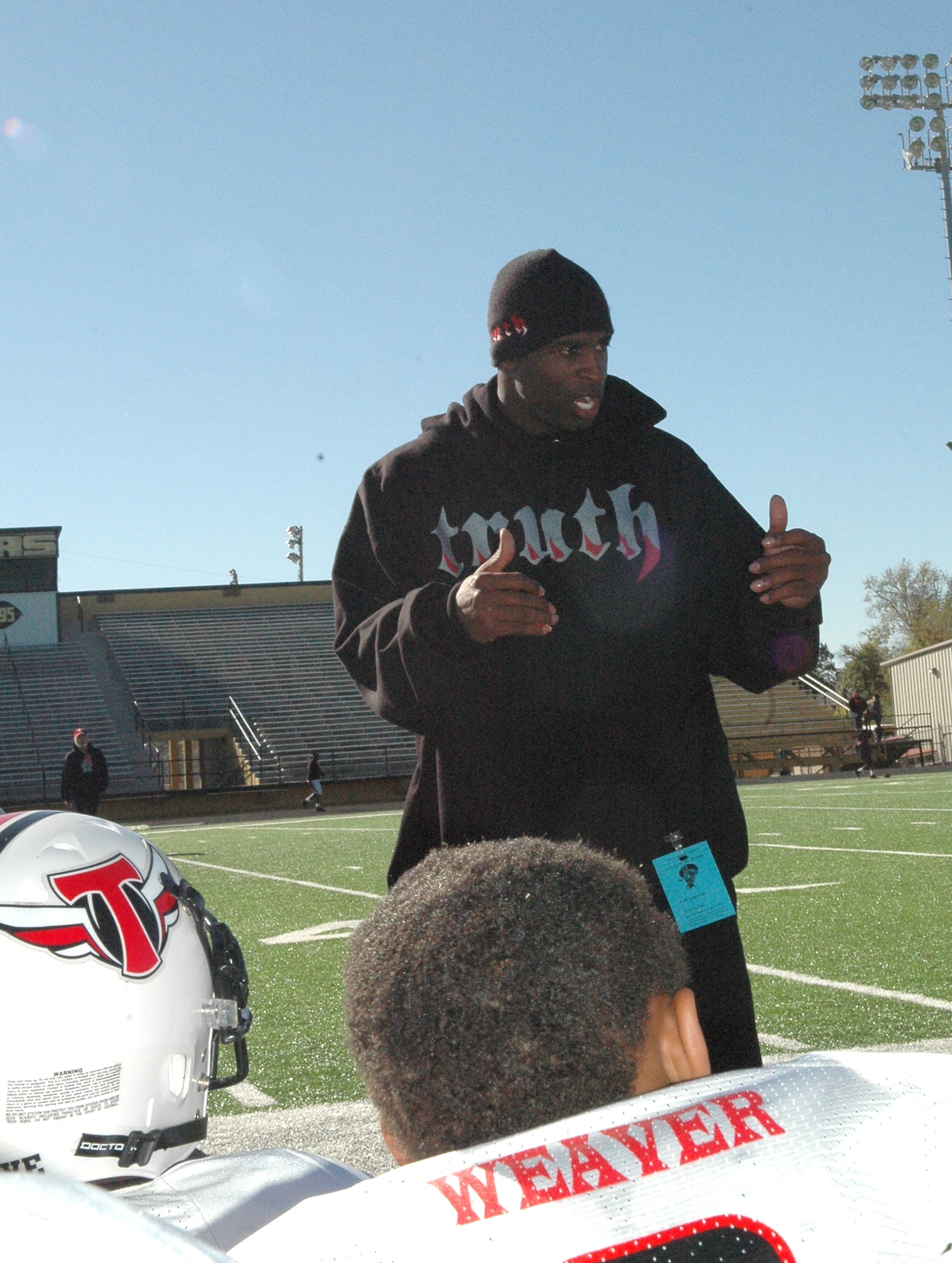 Deion Sanders, legendary NFL cornerback, coaches boys from the Truth program 7 and 8-year-old youth football team. Mr. Sanders started the Truth program as a way to mentor boys, teaching them fundamental values and discipline and allowing them to “expand their view.” (Air Force photo by Micah Garbarino)