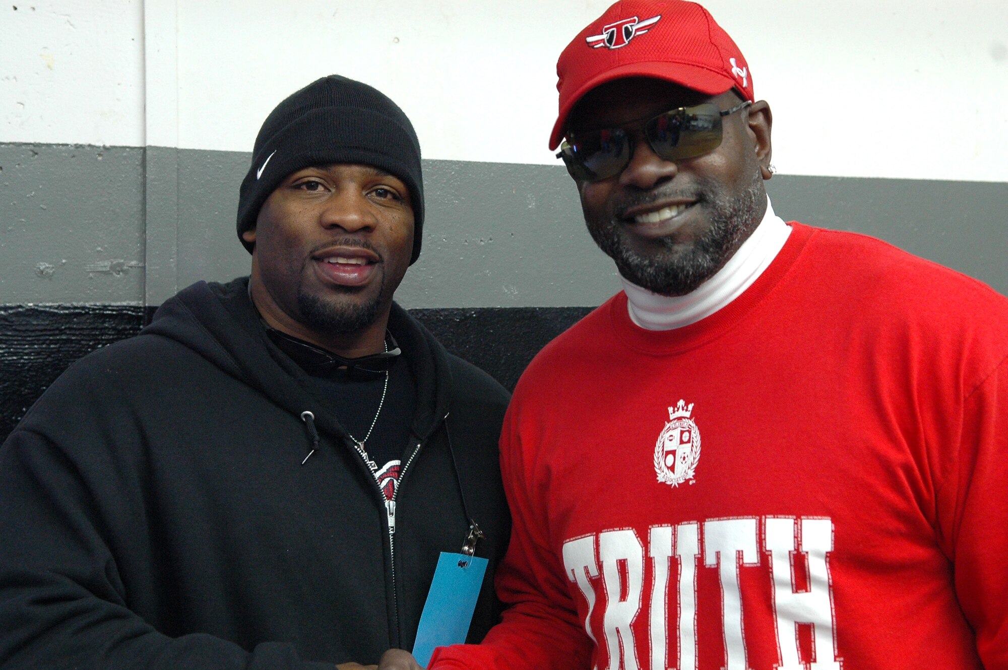 Tracy Walker, left, a recreation assistant with the 72nd Force Support Squadron, coached opposite NFL Hall of Famer Emmitt Smith and Deion Sanders during a youth football game in Midwest City Saturday. Emmitt Smith said coaches like Mr. Walker are the unsung heroes in football who volunteer their time to coach kids that go on to become great players. (Air Force photo by Micah Garbarino)
