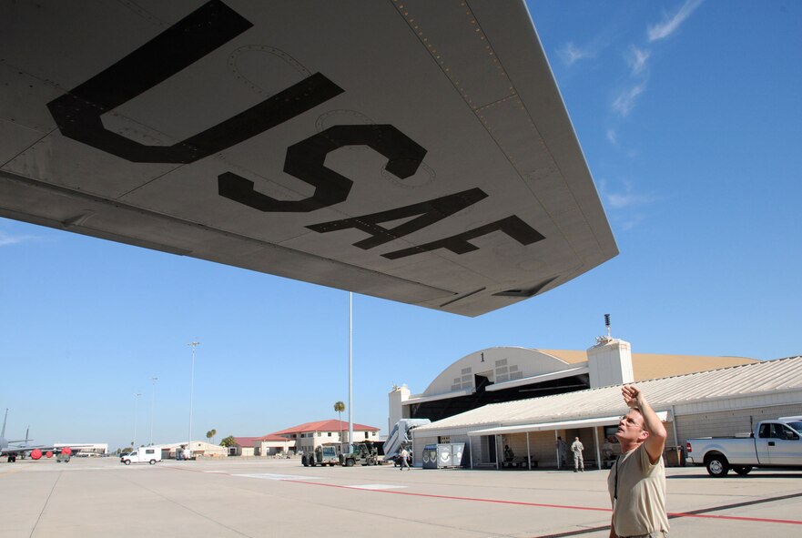 MacDill Air Force Base, Fla. --  Senior Airman Kyle Steady, a crew chief with the 927th Air Refueling Wing, braves the afternoon sun here to make sure there were no leaks around the wings of a KC-135 tanker aircraft. Steady participated in a recent operational readiness exercise that required the unit to deploy airplane tankers to refuel tactical aircraft on short notice.  Steady has the responsibility of making sure the plane was flight-ready at all times. (Official United States Air Force photo by Staff Sgt. Shawn C. Rhodes)