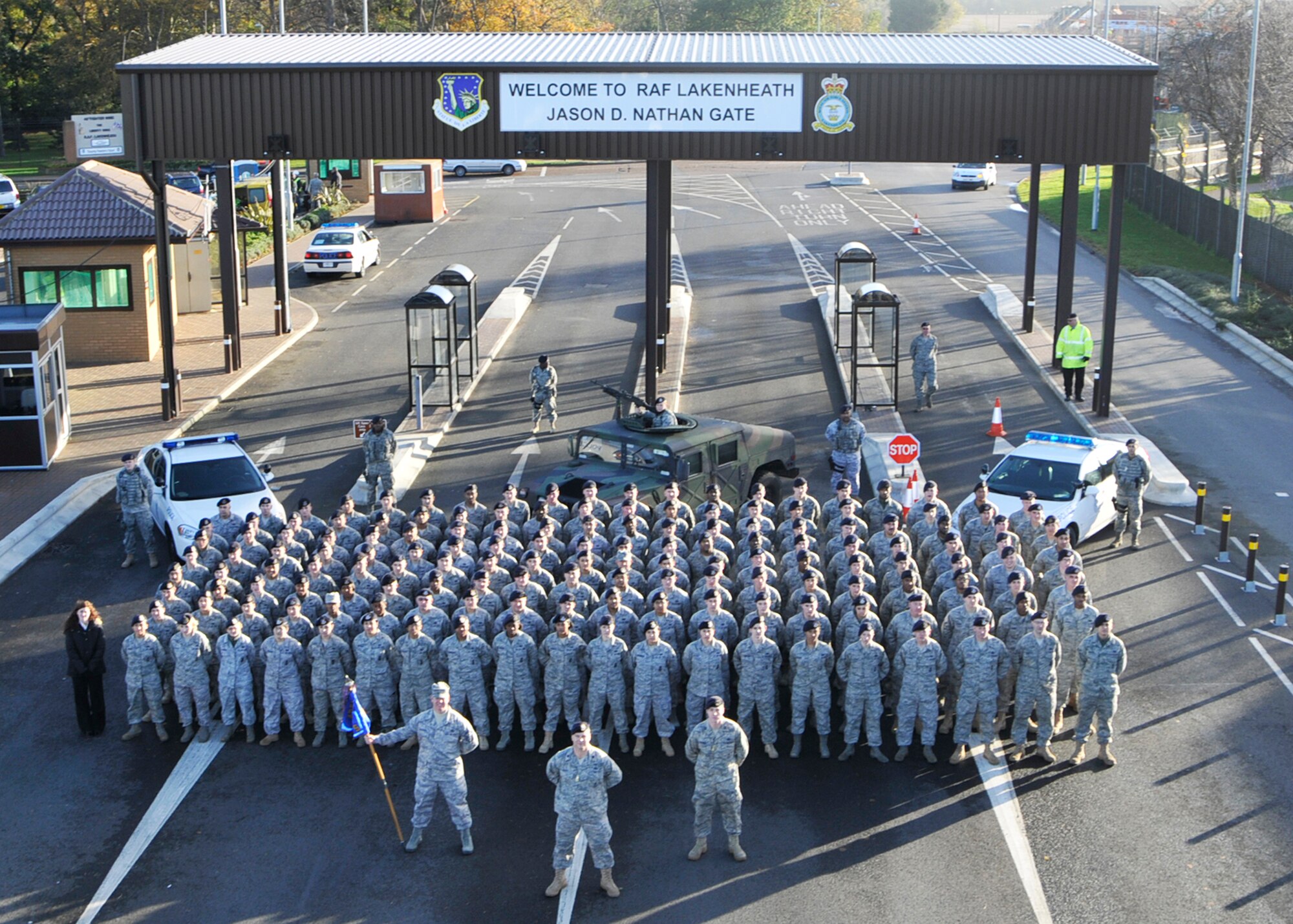 ROYAL AIR FORCE LAKENHEATH, England – Airmen from the 48th Security Forces Squadron stand in formation in front of Gate 2, renamed Jason D. Nathan Gate during a dedication ceremony on Nov. 12. Senior Airman Nathan, a former Airman of the 48th SFS, was killed in action during a tour in Iraq in June of 2007. (U.S. Air Force photo/Airman 1st Class Tiffany M. Deuel)
