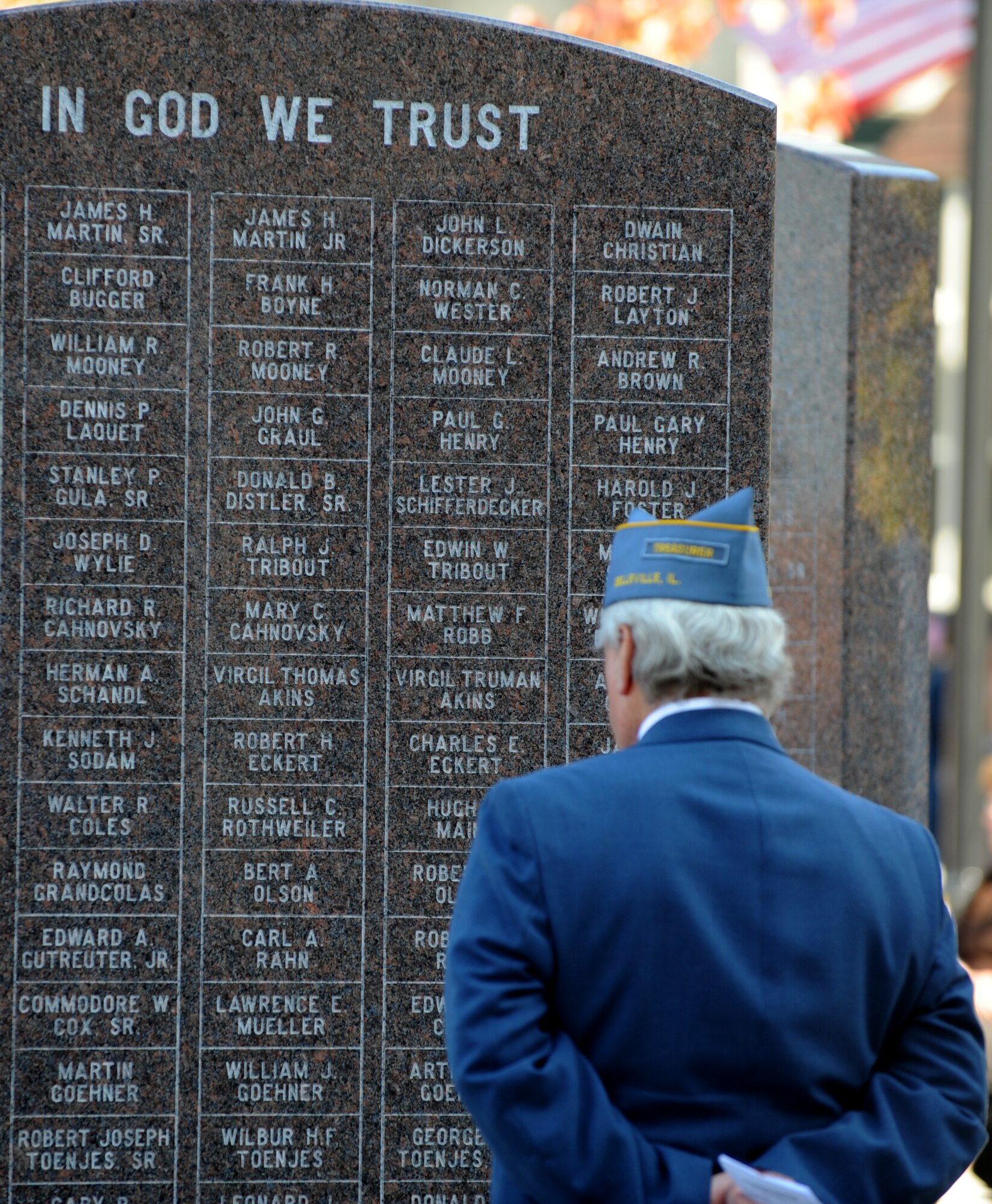 A retired veteran reads the names engraved on the Veteran's Memorial Monument in the center of Belleville, Ill. during a Veterans Day ceremony, Nov. 11, 2010. The monument honors those who have fought in the major wars of the twentieth century. During the ceremony veterans both past and present were honored and thanked for their service and sacrifice for their country. (U.S. Air Force photo by Staff Sgt. Brian J. Valencia)