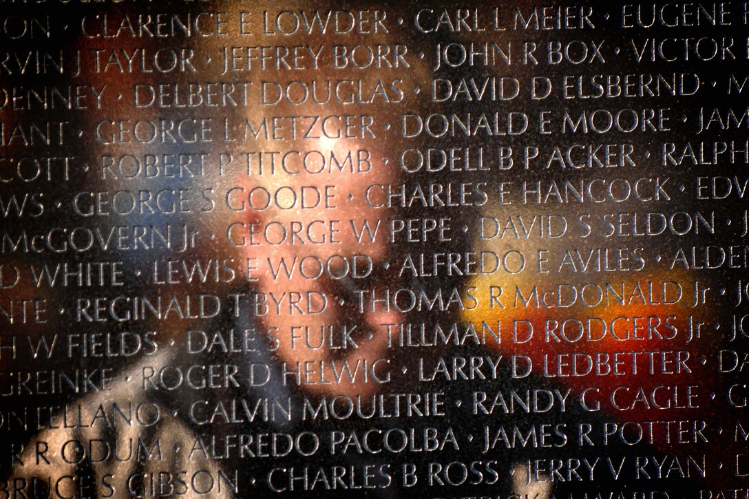Christopher Smallwood cries at the Vietnam Veterans Memorial in Washington, D.C., Nov. 11, 2010. His father's name, Eugene F. Smallwood, is etched into the memorial. He died in service in Vietnam, Sept. 8, 1969.