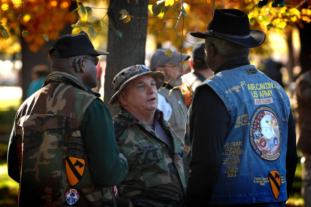 Abraham Brown, from South Carolina, talks with Bernie Klemanek, center, from Virginia, at the Vietnam Veterans Memorial Veterans Day observance at the National Mall, Washington, D.C., Nov. 11, 2010.