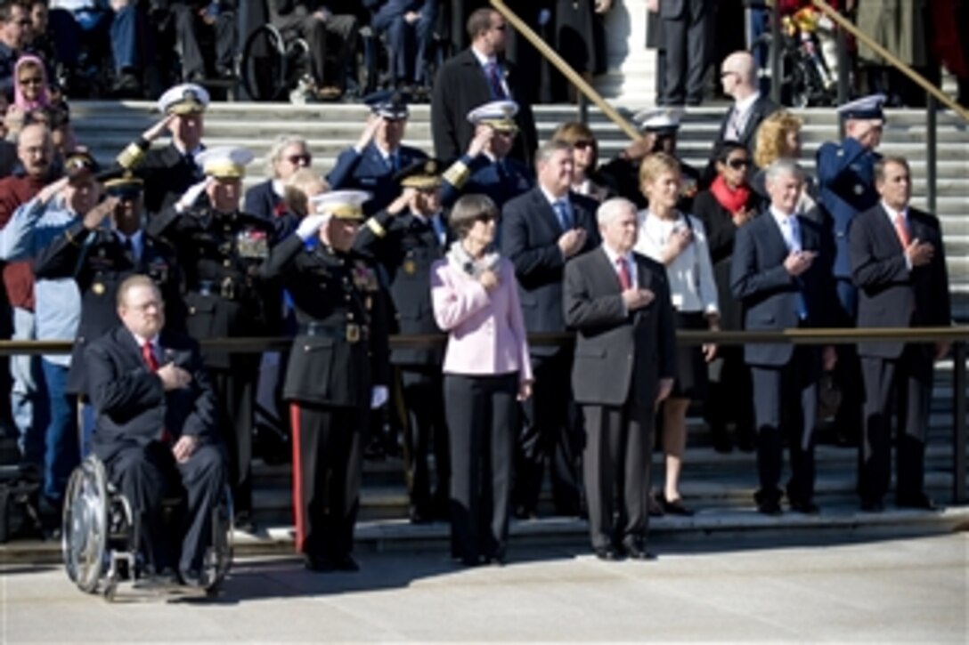Secretary of Defense Robert M. Gates, Vice Chairman of the Joint Chiefs of Staff Gen. James Cartwright and other senior defense officials render honors during the playing of the national anthem as part of a Veteran's Day ceremony at the Tomb of the Unknown Soldier at Arlington National Cemetery in Arlington, Va., on Nov. 11, 2010. 