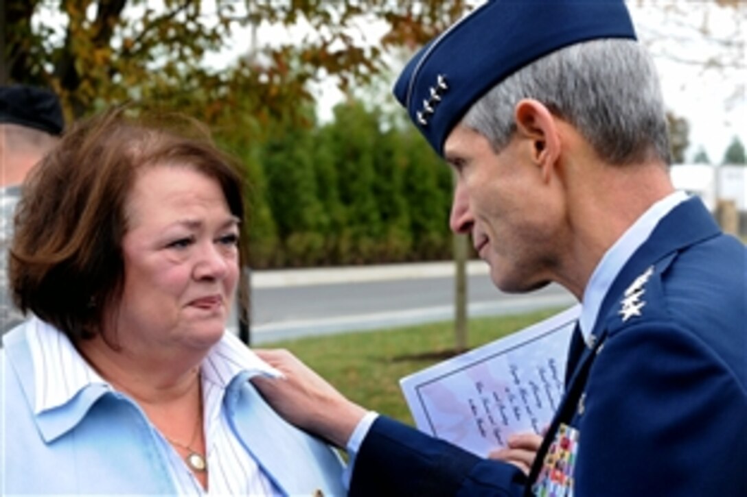Air Force Chief of Staff Gen. Norton Schwartz, right, consoles Judy Faunce of Wilmington, Del., following a dedication ceremony for the Fisher House for Families of the Fallen, Nov. 10, 2010, at Dover Air Force Base, Del.  Faunce's son, U.S. Army Capt. Brian Faunce, was killed in service in 2003.
