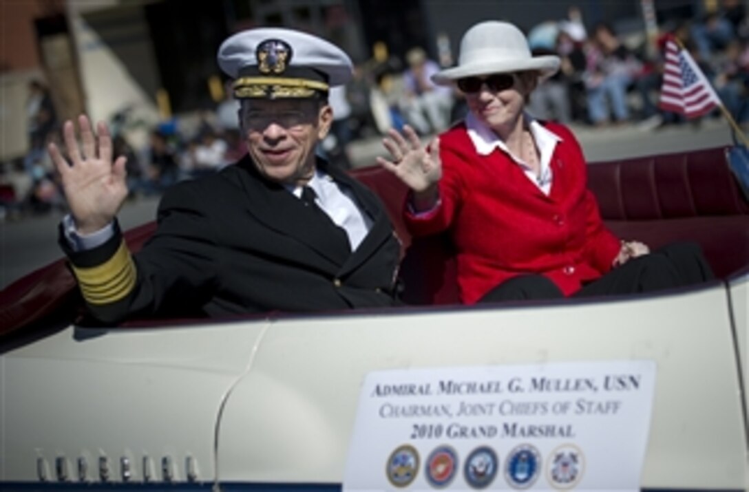 Chairman of the Joint Chiefs of Staff Adm. Mike Mullen, U.S. Navy, Grand Marshal of the 7th Annual San Fernando Valley Veteran's Day Parade, and his wife Deborah wave to parade attendees in Pacoima, Calif., on Nov. 11, 2010.  